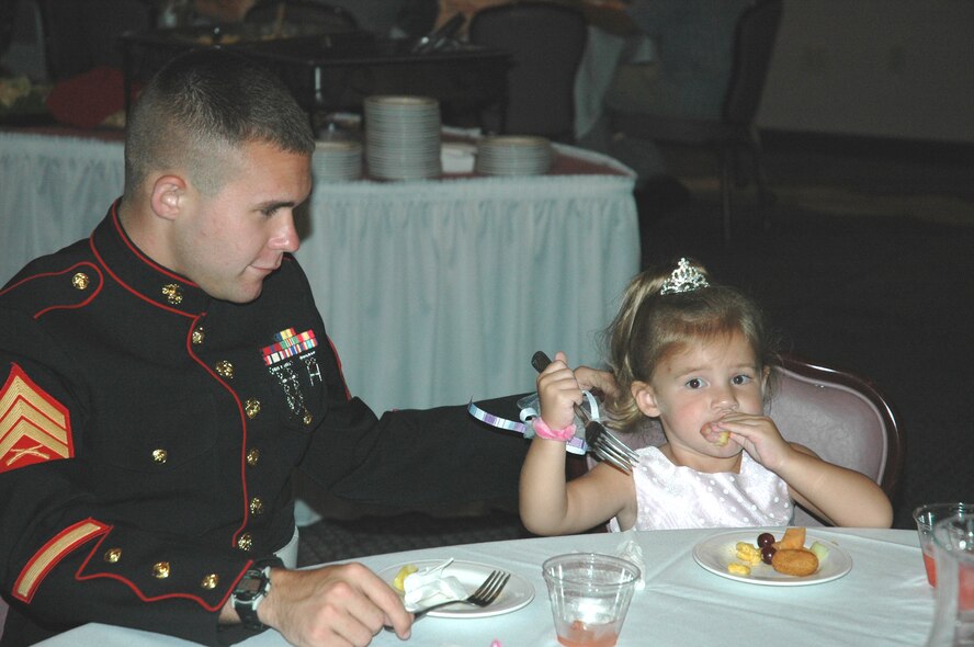 U.S. Marine Corps Sergeant Paul Rogers, local service recruiter, and his daughter Julia, enjoy hors d'oeuvres and beverages during the "Daddy Daughter Dance" hosted by the 325th Services Squadron July 24. Tyndall fathers brought their daughters out for a night of food, friends, dancing and fun at the Tyndall Heritage Club. 
