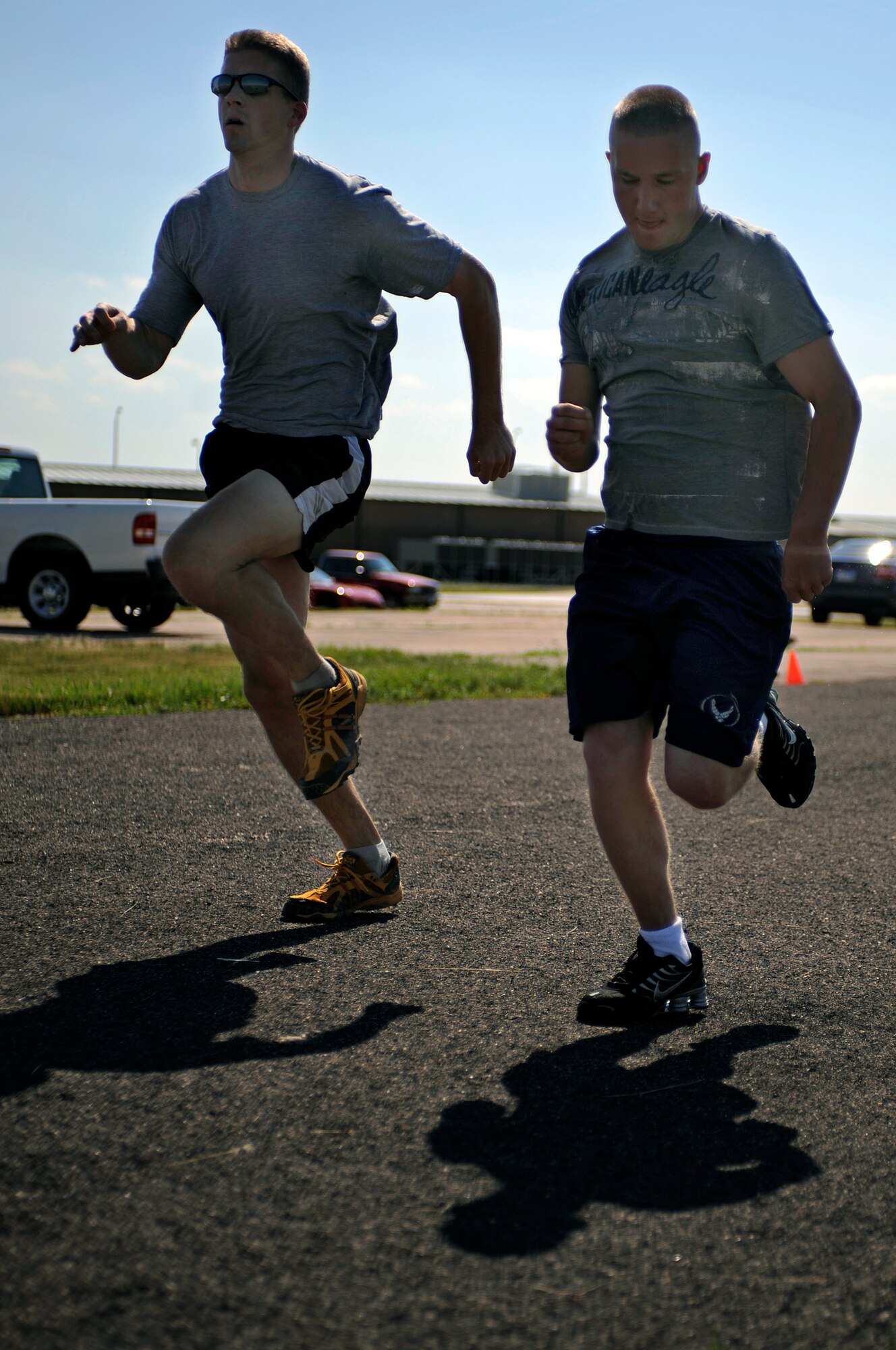 ELLSWORTH AIR FORCE BASE, S.D. -- (left) Capt. Joe Rozak, 28th Operations Supports Squadron weather flight commander, races against Airman 1st Class Chadwick Richardson, 28th Security Forces Sqadron response member, in the quarter-mile race of the Iron Flight competition here July 31.  Captain Rozak won the event, helping 28 OSS win the competition. (U.S. Air Force photo/Airman Matthew Flynn)