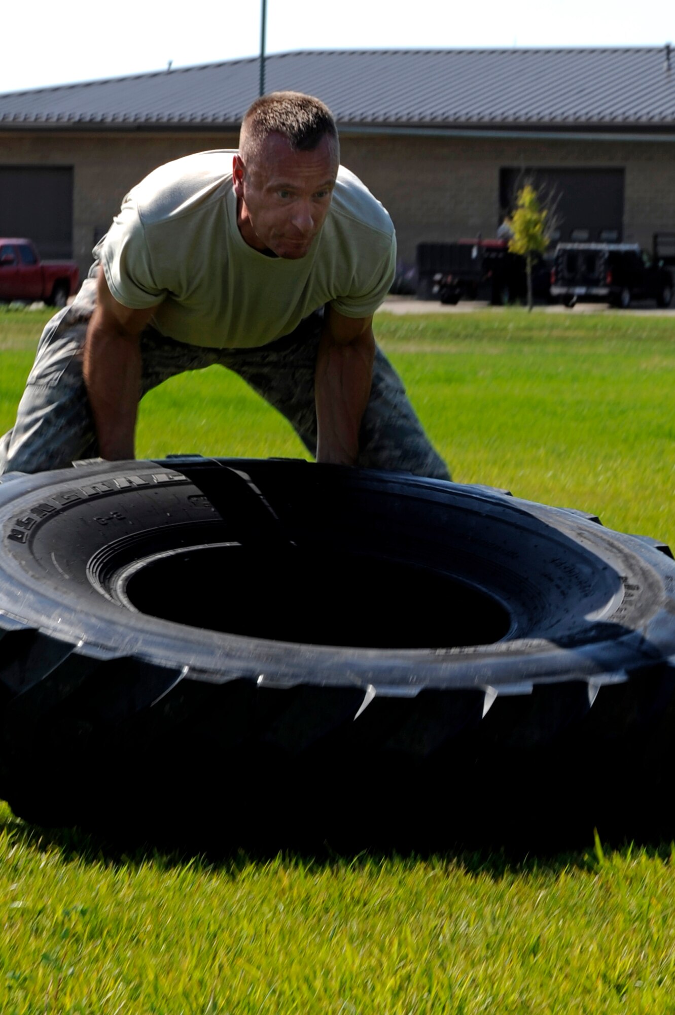 ELLSWORTH AIR FORCE BASE, S.D. -- Capt. Ren Carr, 28th Security Forces Squadron operations officer, participates in the tire flip event in the Iron Flight competition here July 31. The competition had six events including the truck pull, quarter-mile run and tug-of-war. (U.S. Air Force photo/Airman Matthew Flynn)