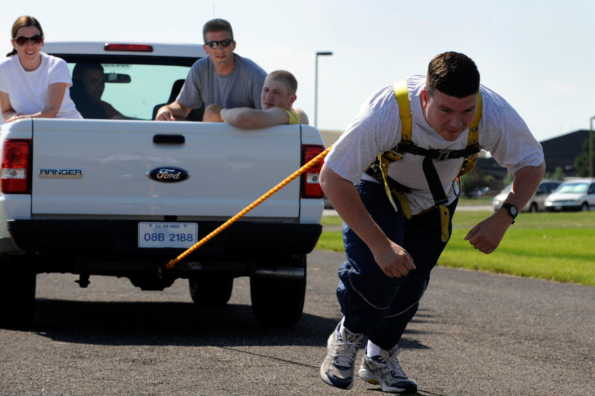 ELLSWORTH AIR FORCE BASE, S.D. -- Capt. Daniel Durr, 28th Operations Support Squadron airfield operations flight commander, pulls a truck occupied with his teammates during the Iron Flight competition here July 31. The competition consisted of six events, including the tire flip, sandbag race and obstacle course. (U.S. Air Force photo/Airman Matthew Flynn)