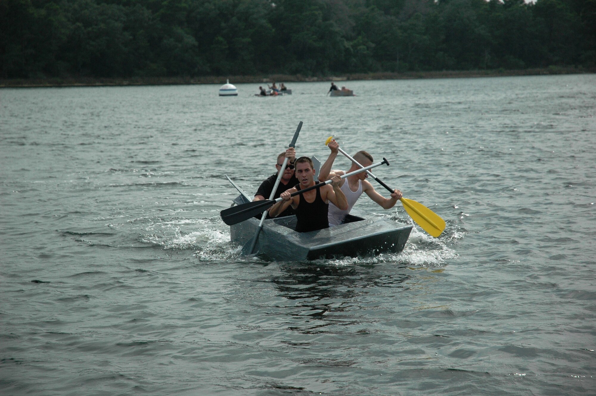 The winning team paddles hard to reach shore during the final stretch of the 2008 325th OSS Regatta Boat Race held July 25 at the Bonita Bay Recreation Center.