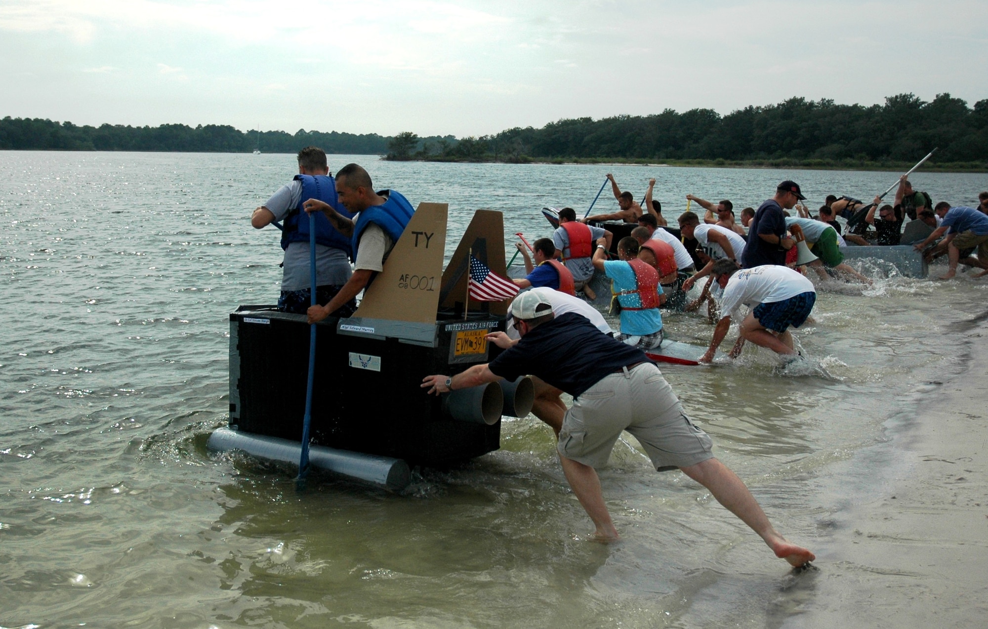Teams from the 325th Operations Support Squadron launch hand-made cardboard watercraft into Bonita Bay during the 2008 325th OSS Regatta Boat Race held July 25 at the Bonita Bay Recreation Center. Hand-crafted cardboard boats were built by flights and sections within the squadron, and were tested for speed and seaworthiness during the competitive squadron event.