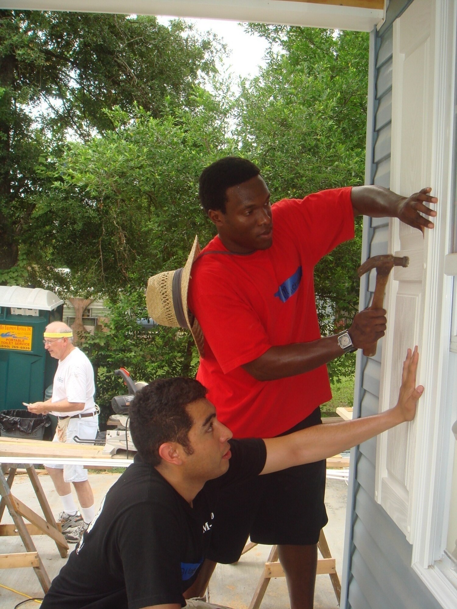 Albert Espinoza (bottom left) and Michael Hawkins, both U.S. Air Force Academy cadets,  participated in a local "Habitat for Humanity" volunteer opportunity during a two-week Tyndall base visit in July. A program hosted by the Air Force Academy, which is called Operations Air Force, allows cadets to shadow officers and enlisted members at installations throughout the Air Force. During their stay at Tyndall, the cadets shadowed officers, toured the installation and participated in community relations events.