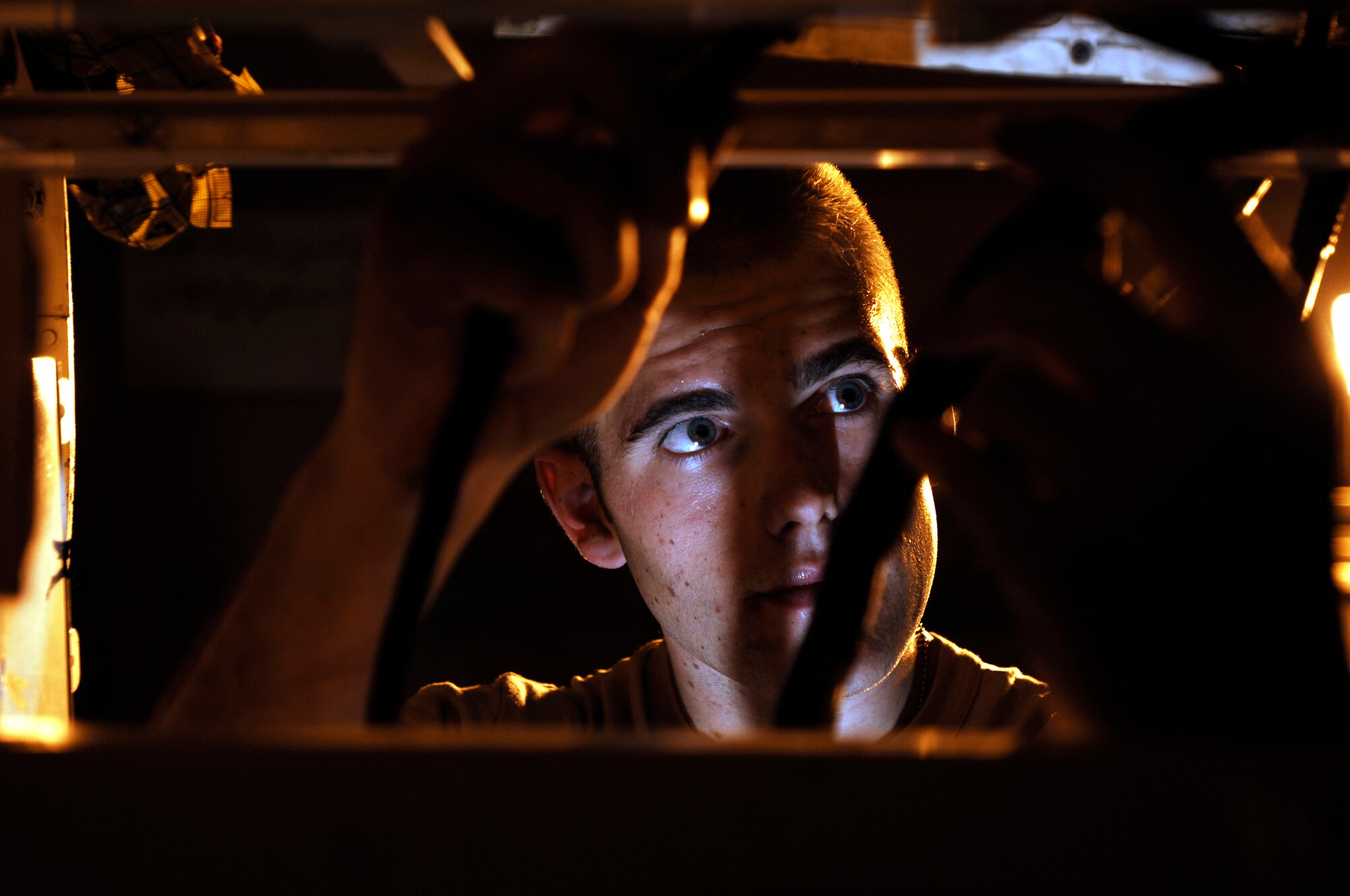 JOINT BASE BALAD, Iraq -- Staff Sgt. Prentiss Hyde installs a radar rack into an F-16 Fighting Falcon here July 31. The radar rack powers the F-16's radar package allowing the pilot to detect aircraft and guide bombs onto targets. Sergeant Hyde, an avionics craftsman with the 77th Expeditionary Fighter Squadron deployed from Shaw Air Force Base, S.C. (U.S. Air Force photo/Airman 1st Class Jason Epley)