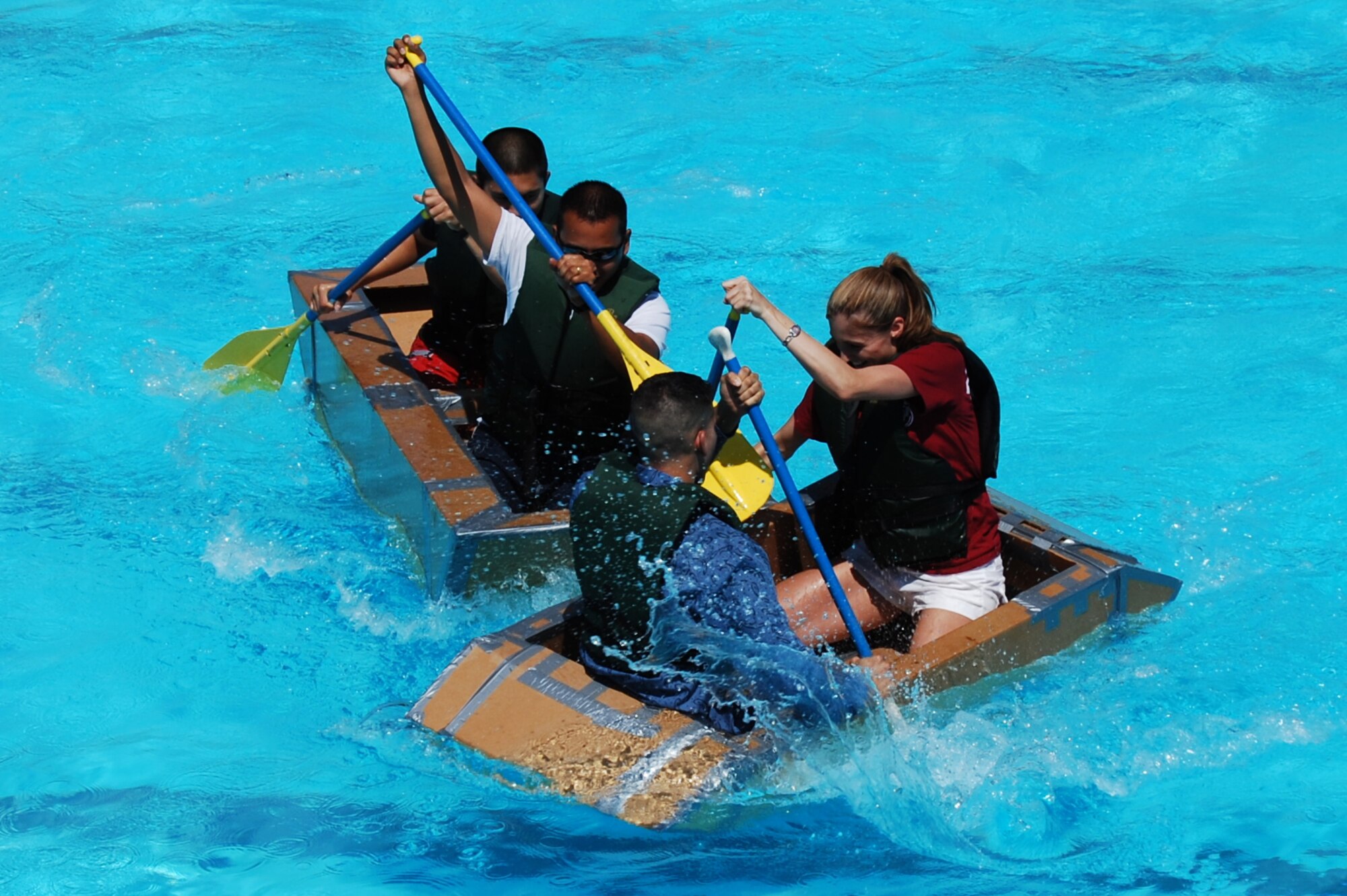 Staff Sgt. Matthew-Ross Cruz and Senior Airman Titus Baluyot, both 43rd Civil Engineer Squadron, and Senior Airmen Christie Zell and AdragelLegarda, both 43rd Medical Support Squadron, race against each other during the 2008 Pope Regatta July 24 at the Pope pool. (U.S. Air Force Photo by Staff Sgt. Brian Margavich)