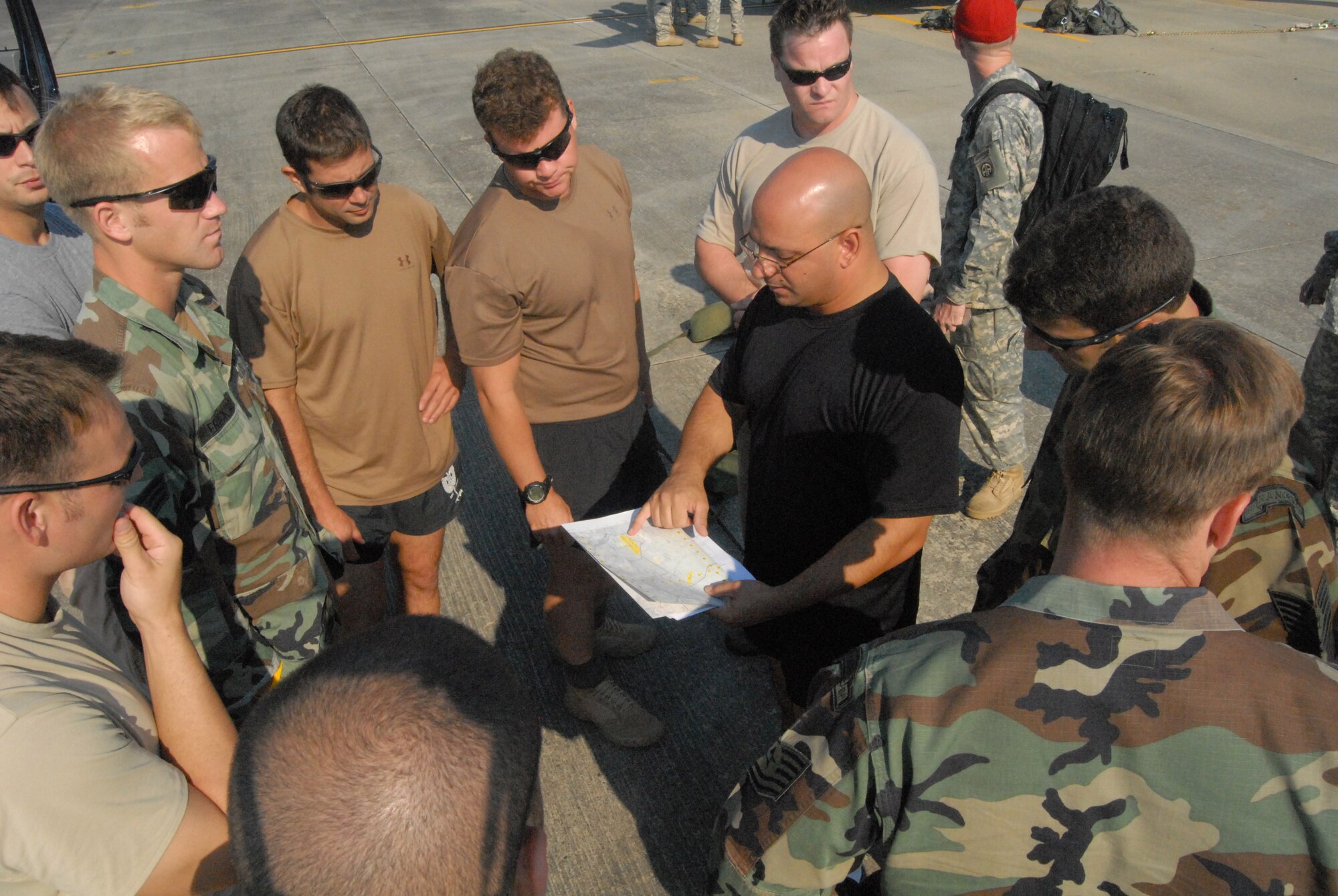 Airmen from the 93rd Air Ground Operations Wing look on as Master Sgt. Jason Colon, 18th Weather Squadron first sergeant, provides instruction on the day’s upcoming jumps July 16 at Simmons Army Airfield. Prior to the first jump of the day, the Airmen received information about the drop zone they would be landing on, the weather conditions for the day and specifics on the aircraft they’d be jumping from. (U.S. Air Force Photo by 2nd Lt. Chris Hoyler)