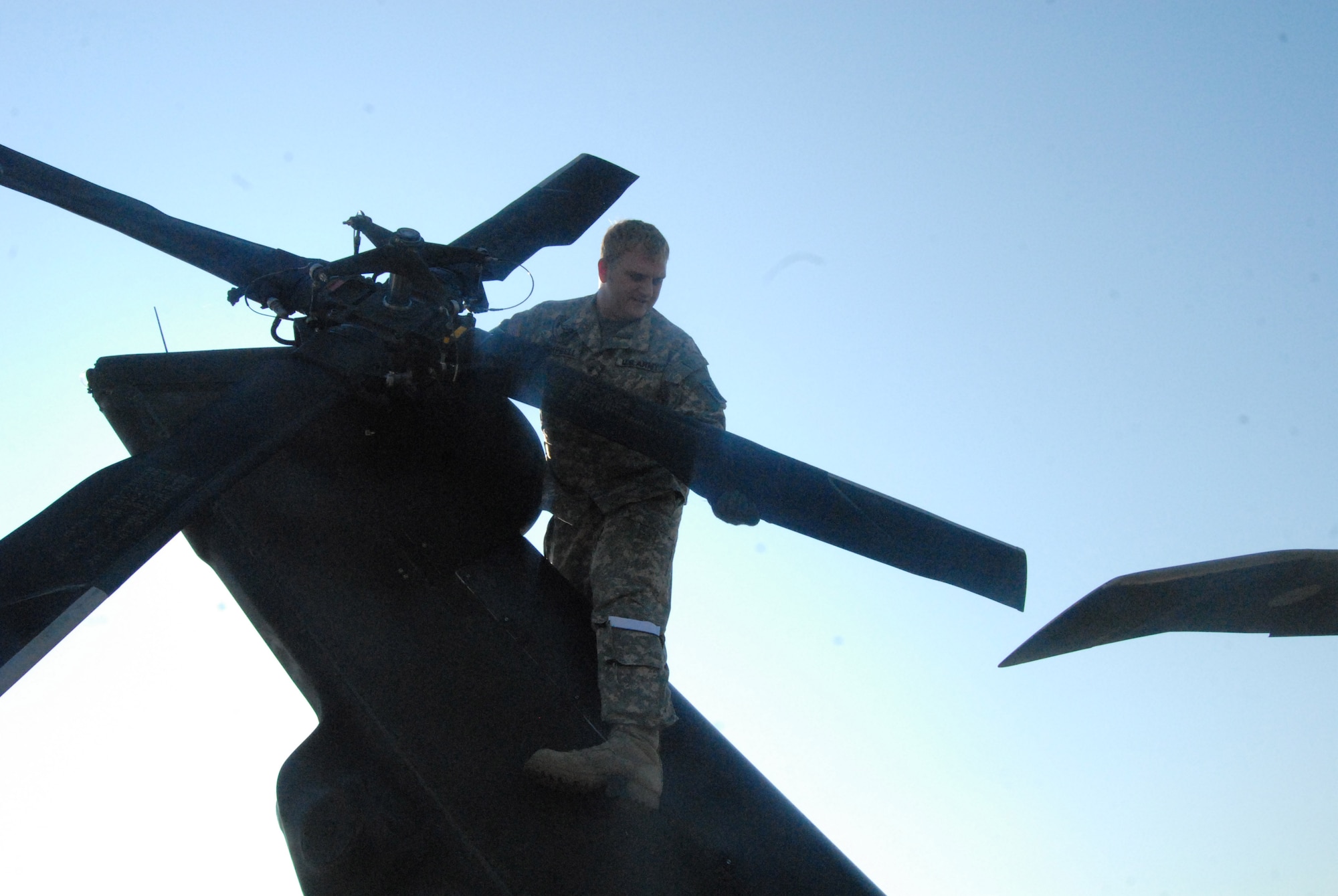 Chief Warrant Officer Mike Campbell, a UH-60 Black Hawk pilot, performs a routine maintenance check on the tail rotor of his aircraft prior to takeoff from Simmons Army Airfield July 16. (U.S. Air Force Photo by 2nd Lt. Chris Hoyler)