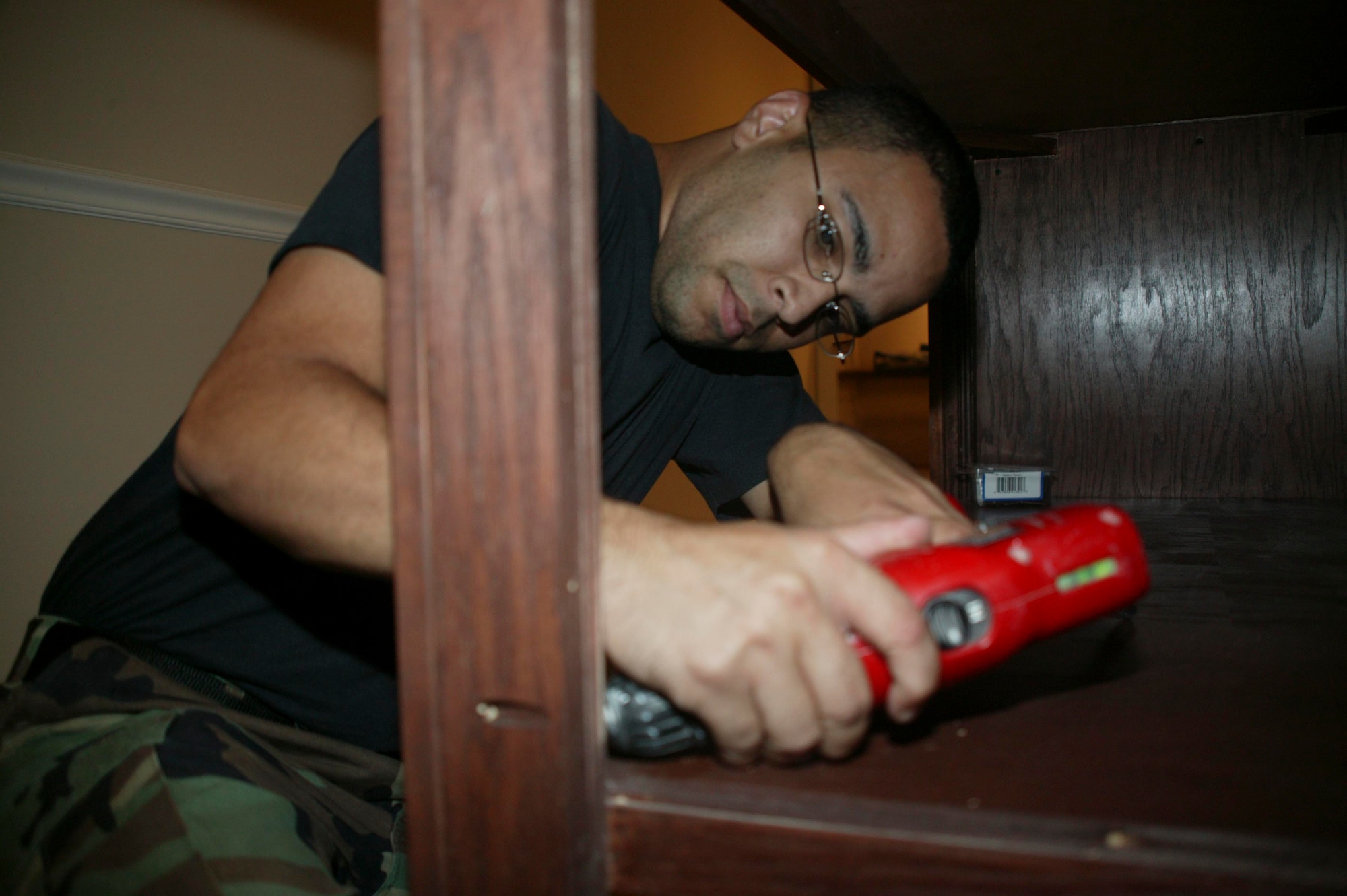 SHAW AIR FORCE BASE, S.C.-- Senior Airman Michael Sheppard, project team member, drills behind the new bar in the new Distinguished Visitors Lounge in Hangar 1200 July 30. Col. James Post, 20th Fighter Wing commander, made the decision to turn a portion of Hangar 1200 into a ceremonial center in August, 2007 and the renovations began in March, 2008. (U.S. Air Force photo/Staff Sgt. Holly Brown) 