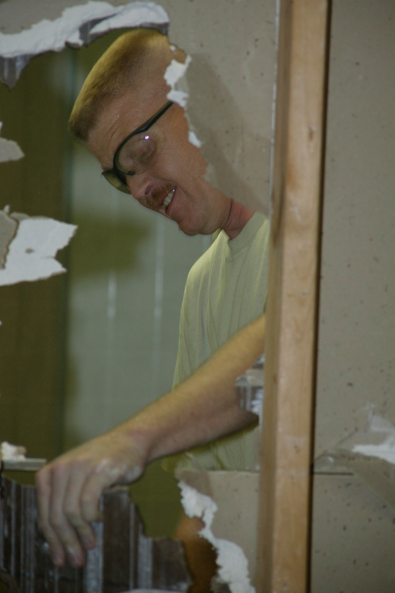 SHAW AIR FORCE BASE, S.C.-- Tech. Sgt. Peter St. Onge, assistant project manager, tears down a wall between the men and women's restrooms as part of the renovation of Hangar 1200 July 30. Col. James Post, 20th Fighter Wing commander, made the decision to turn a portion of Hangar 1200 into a ceremonial center in August, 2007 and the renovations began in March, 2008. (U.S. Air Force photo/Staff Sgt. Holly Brown)