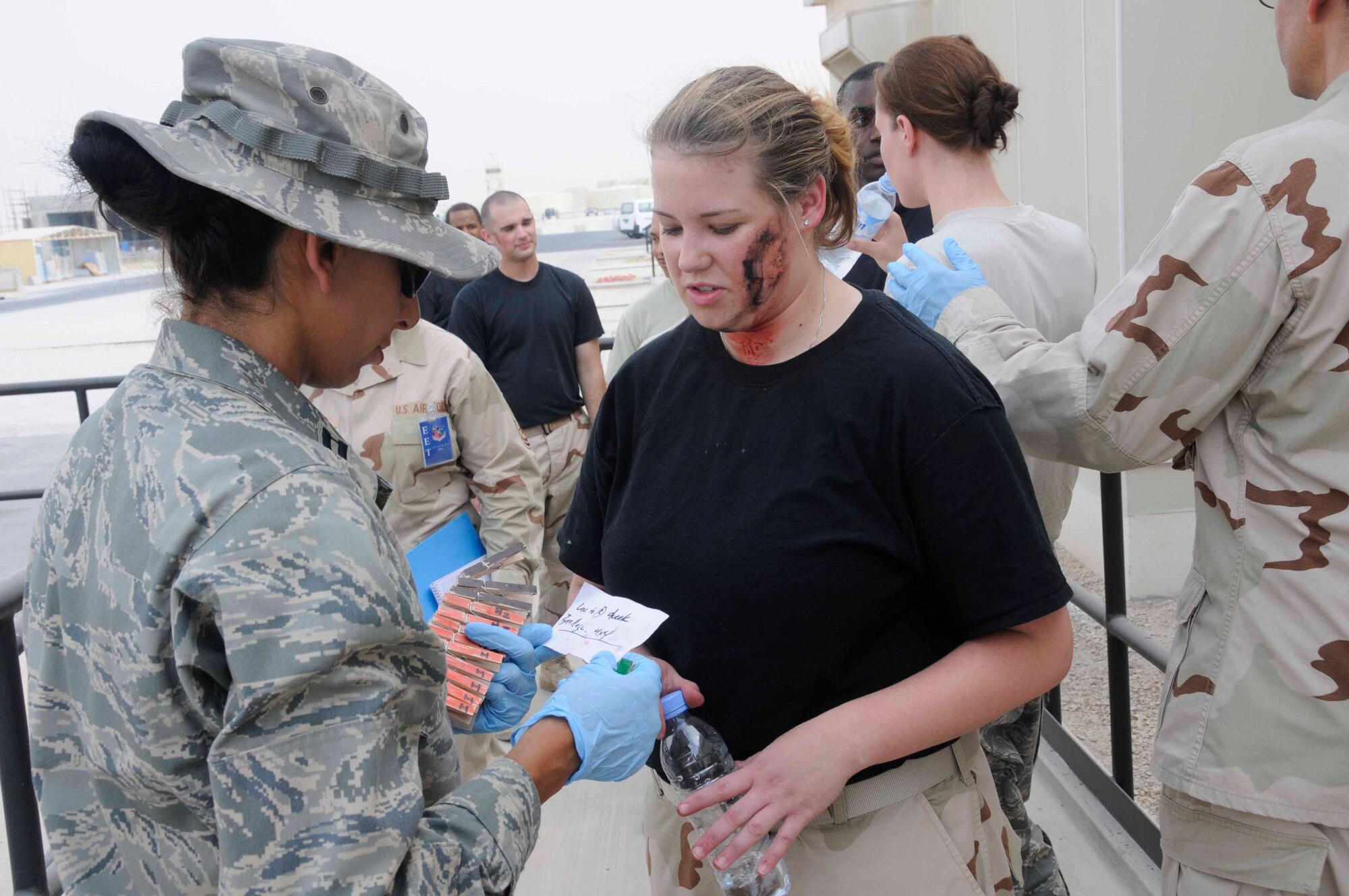 Captain Humaira Masood, 379th Expeditionary Medical Group, checks the status of a simulated injured Airman to determine the type of care needed during a Major Accident Response Exercise in Southwest Asia July 28. The goals of the exercise were to hone the skills of first responders and to practice incident command and control. Approximately 500 people from organizations across the base were involved in the exercise, which simulated an aircraft mishap resulting in two dozen injured Airmen. Captain Masood is deployed from Lackland Air Force Base, Texas. (U.S. Air Force photo by Staff Sgt. Darnell T. Cannady)