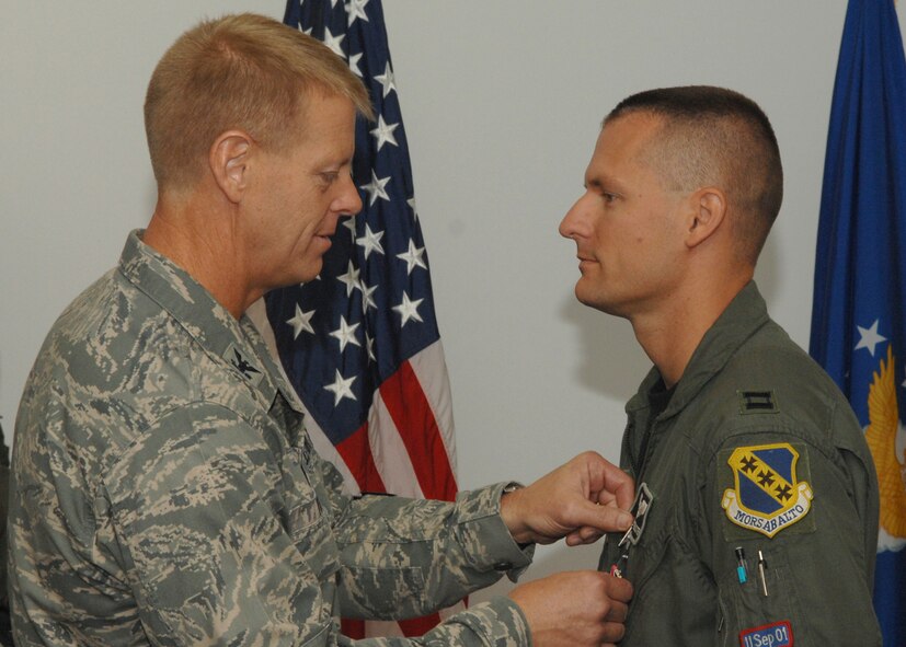 DYESS AIR FORCE BASE, Texas – Capt. Jason Register is presented with the Bronze Star Medal by Col. Donald Tharp, 3rd Air Support Operations Group commander, July 31. He received the BSM for his deployed service as air liaison officer for Army battalions while deployed to Iraq Oct. 24, 2006, to April 24, 2007. (U.S. Air Force photo by Senior Airman Jennifer Romig)