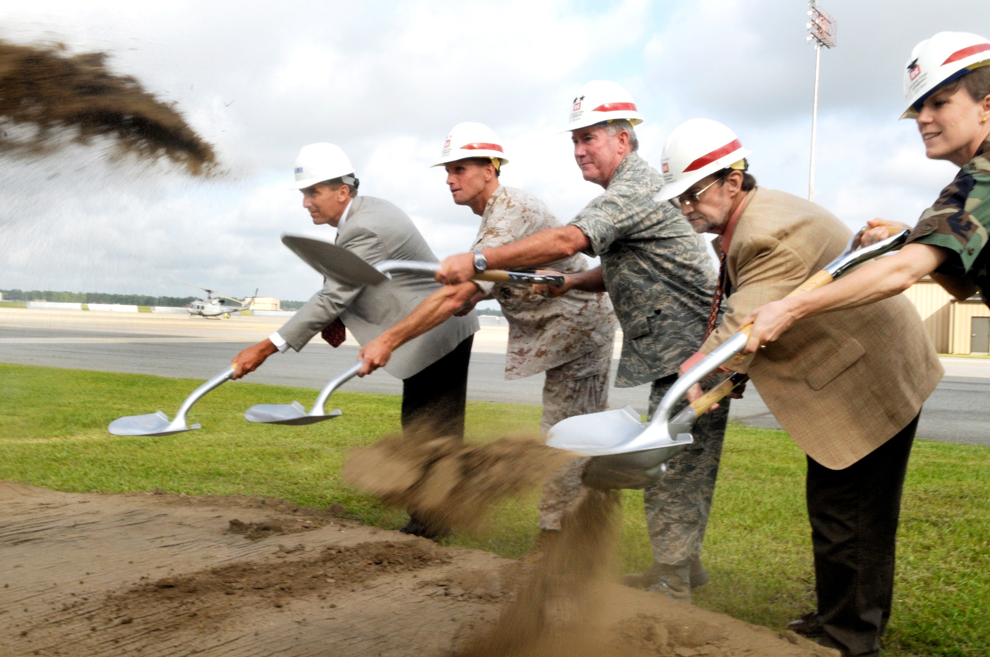 Thomas Troutman, New South executive vice president, Colonel Lance Maffett, 4th Marine Aircraft Wing commander, Major General Tom Owen, Warner Robins Air Logistics Center commander, Ric Powers, US Army Corps of Engineers area engineer, and Colonel Debra Bean, 78th Air Base Wing vice commander break ground for a new Marine Light/Attack Helicopter Squadron 773 hangar July 30. U. S. Air Force photo by Sue Sapp