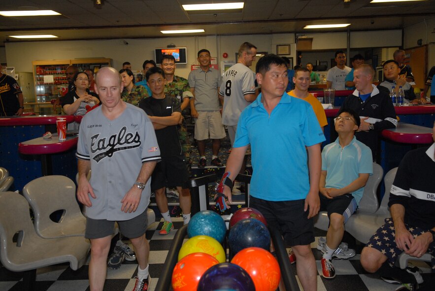 KUNSAN AIR BASE, Republic of Korea -- Wolf Pack Airmen and Republic Of Korea Airmen participate in a friendly bowling completion here Aug. 1. The Force Support Squadron gave out first, second and third place prizes for the best teams, there were six Wolf Pack teams and six ROCAF teams total.( US Air Force Photo By:Senior Airman Angela Ruiz)