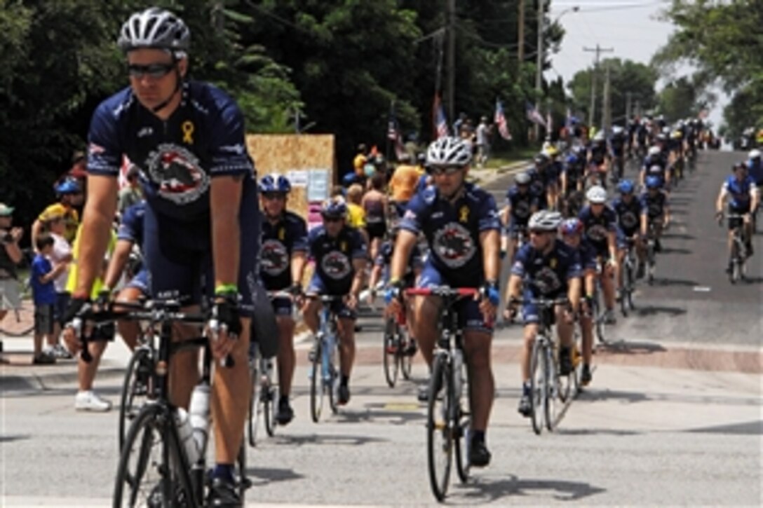 Members of the Air Force Cycling Team ride through cheering crowds at the completion of the Registers Annual Great Bike Ride Across Iowa in Le Claire, Iowa, , July 26, 2008. The team has been participating in the event for the past 14 years.