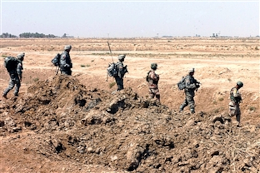 U.S. and Iraqi soldiers head out during an air assault mission geared toward forcing insurgents out of the village of Al Fatah Miaya near Tikrit, Iraq, July 25, 2008. The soldiers are assigned to Troop G, 2nd Squadron, 3rd Armored Cavalry Regiment. 
