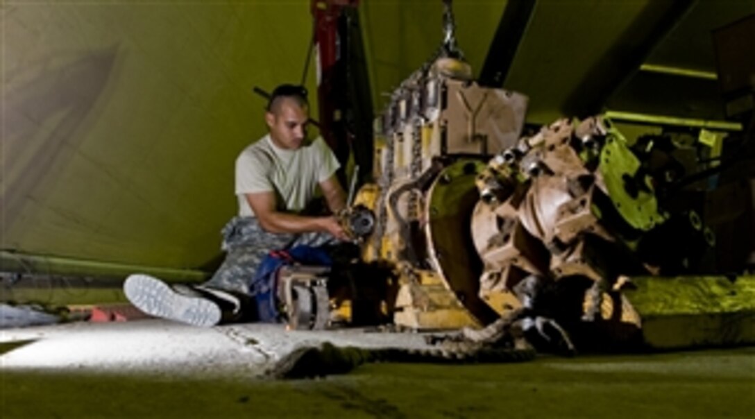 U.S. Air Force Senior Airman Aurelio Felix, a vehicle maintainer with the 407th Expeditionary Logistics Readiness Squadron, works on a Bomag Roller engine at Ail Air Base, Iraq, on July 30, 2008.  The vehicle maintenance shop is in charge of maintaining all Air Force vehicle assets, which includes more than 300 vehicles and other heavy machinery.  Due to the severe heat and sandy conditions in Iraq, vehicle oil changes are accomplished more frequently and various components have increased failure rates.  