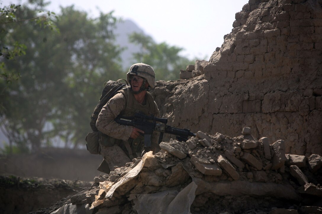 Lance Cpl. Michael Molesta, an infantryman assigned to 1st Platoon, Company F, Task Force 2nd Battalion, 7th Marine Regiment, 1st Marine Division, climbs to the top of a destroyed building in a Taliban headquarters to post security for his platoon.