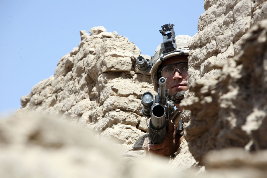 A Marine assigned to Company F, Task Force 2nd Battalion, 7th Marine Regiment, 1st Marine Division, posts security after his platoon breached a Taliban headquarters in recent fighting in NowZad.