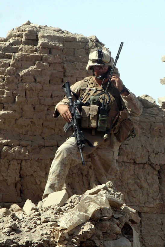 HELMAND PROVINCE, Afghanistan – Captain Ross Schellhaas, commander, Company F, Task Force 2d Battalion, 7th Marine Regiment, 1st Marine Division, and native of Meridian, Idaho, uses a radio to communicate with his platoon commanders following the raid his Marines conducted on a Taliban headquarters building.  (U.S. Marine Corps photo by Cpl. James M. Mercure)