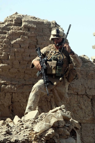 HELMAND PROVINCE, Afghanistan – Captain Ross Schellhaas, commander, Company F, Task Force 2d Battalion, 7th Marine Regiment, 1st Marine Division, and native of Meridian, Idaho, uses a radio to communicate with his platoon commanders following the raid his Marines conducted on a Taliban headquarters building.  (U.S. Marine Corps photo by Cpl. James M. Mercure)