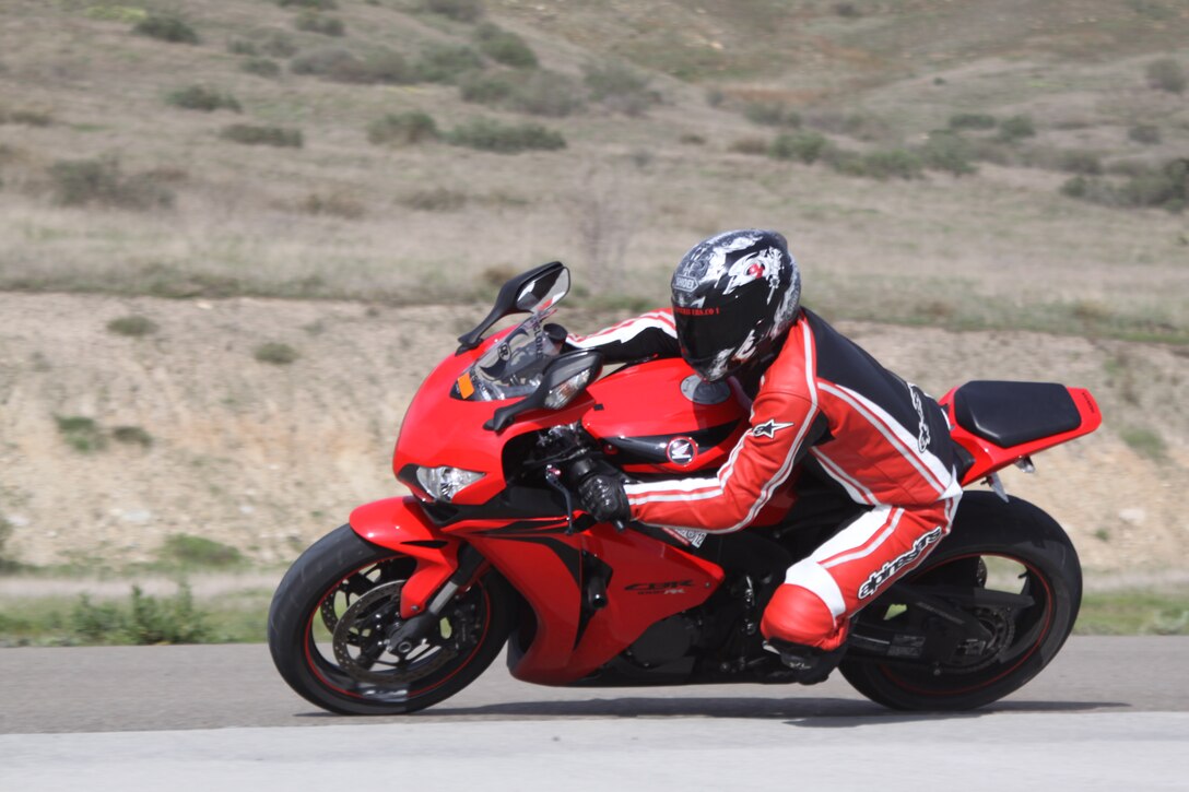 Sgt. Mark Thomas, artillery mechanic, 1st Maintenance Battalion, 1st  Marine Division, applies newly learned turning techniques during Camp Pendleton’s annual Motorcycle Track Day, held at the 62 Area Helicopter Outlying Landing Field, Jan. 30. During the course, service members were given tips on the basics of riding, handling and proper positioning of the body.