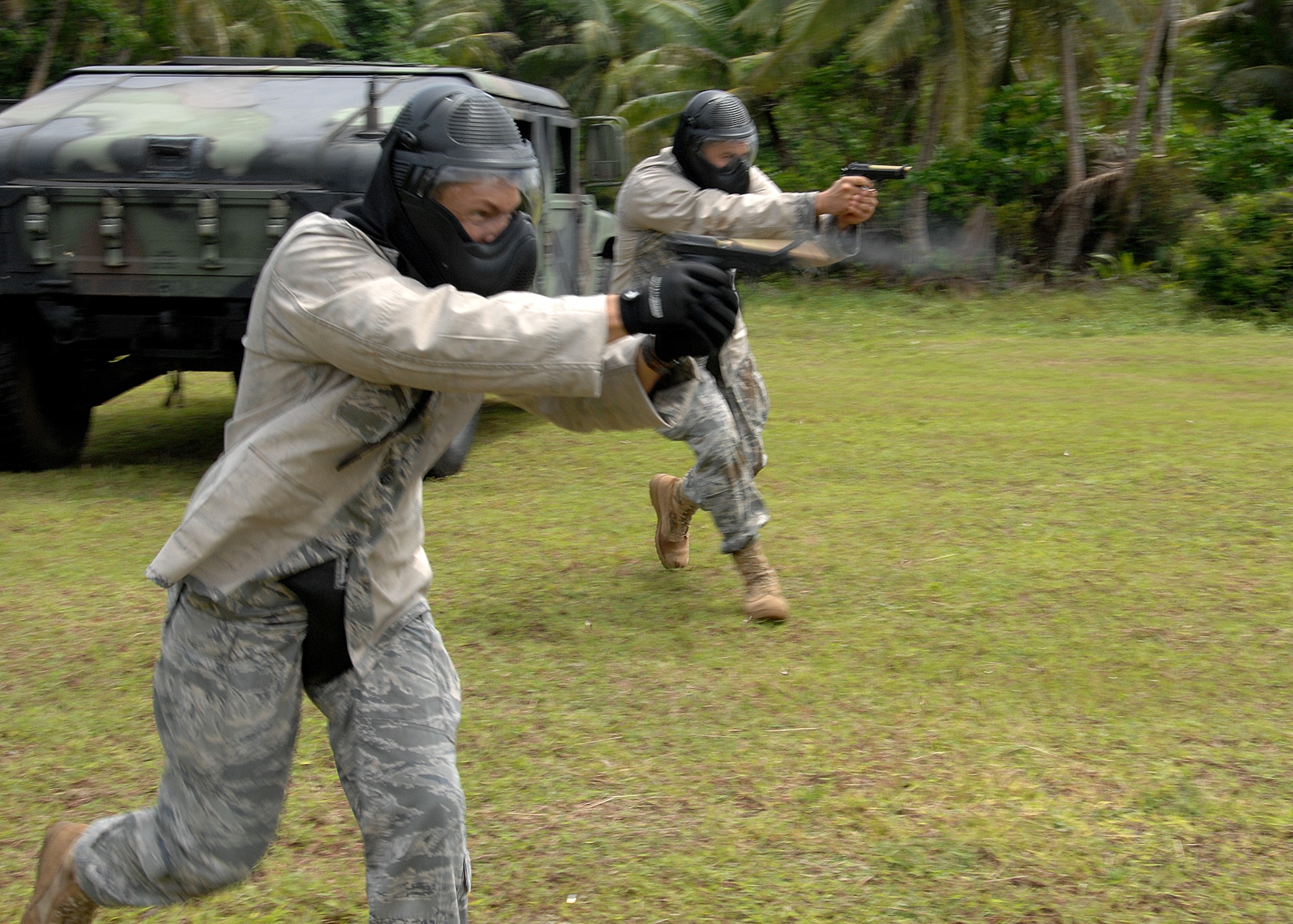 Staff Sgt. Daniel Gonzalez from Kadena Air Base, Japan and Staff Sgt. Robert Bishop from Misawa Air Base, Japan participate in  a live fire scenario during the Commando Warrior Simuntions training exercise July 30 at Andersen Air Force Base, Guam. 
M-9 and M-4 Simunition configured training weapons and colored FX rounds were used during the training course. Security Forces airmen from across  the Pacific Air Forces came together to perform the training hosted by the 736th SFS. (U.S. Air Force photo by Airman 1st Class Nichelle Griffiths)
