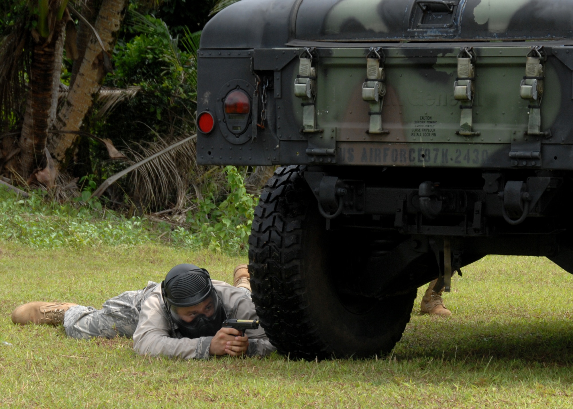 Staff Sgt. Daniel Gonzalez from Kadena Air Base, Japan takes cover during one of many life fire scenarios that took place in Commando Warrior Simuntions training exercise July 30 at Andersen Air Force Base, Guam. The five day  training course brought together Airmen in several Security Forces Squadrons in the Pacific Air Forces. The training was hosted by the 736th SFS and included two days of classroom instruction and three days of field training.(U.S. Air Force photo by Airman 1st Class Nichelle Griffiths)