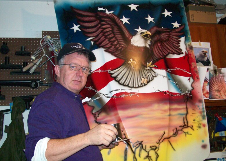 WRIGHT-PATTERSON AFB, Ohio - Master Sgt. Roland Stinnette, 445th Maintenance Operation Flight, paints a patriotic scheme onto the hood of a 1980 Corvette. Sergeant Stinnette took part in this tribute to Vietnam POW's by lending his skills in graphic design and airbrushing, which he learned from his father Harold Stinnette. (Courtesy photo)