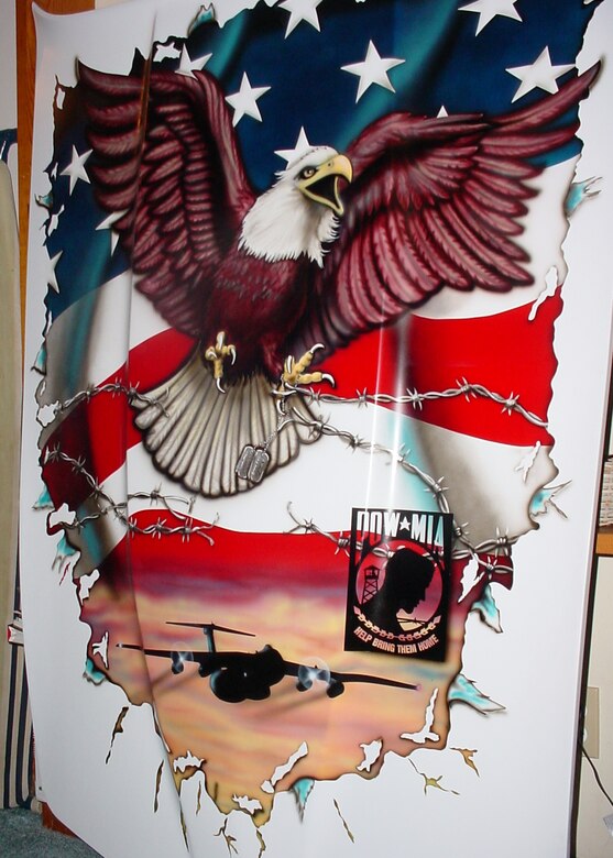 WRIGHT-PATTERSON AFB, Ohio -  A 1980 restored Corvette has a patriotic paint scheme on the hood that includes the two toned paint colors of the Hanoi Taxi, a C-141 Starlifter that was the first C-141 into Hanoi, Vietnam to bring home prisoners of war, a bald eagle, barbed wire, dog tags, and the POW MIA logo. (Courtesy photo)