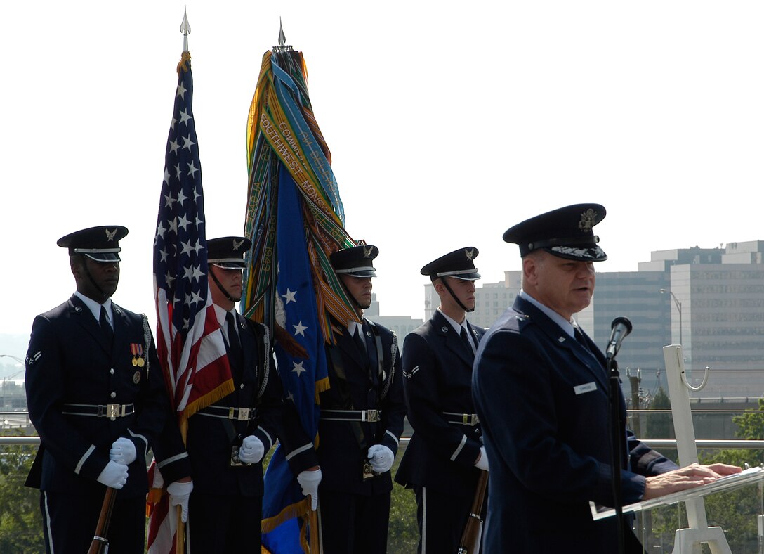 Brigadier General Dana Simmons, Air Force Office of Special Investigations Commander, delivers a speech celebrating 60 years of proud service from the men and women of AFOSI Aug.1 at the Air Force Memorial. Behind him are members of the Air Force Honor Guard, who were on hand to help commemorate the occasion. (U.S. Air Force photo/Tech. Sgt. John Jung)