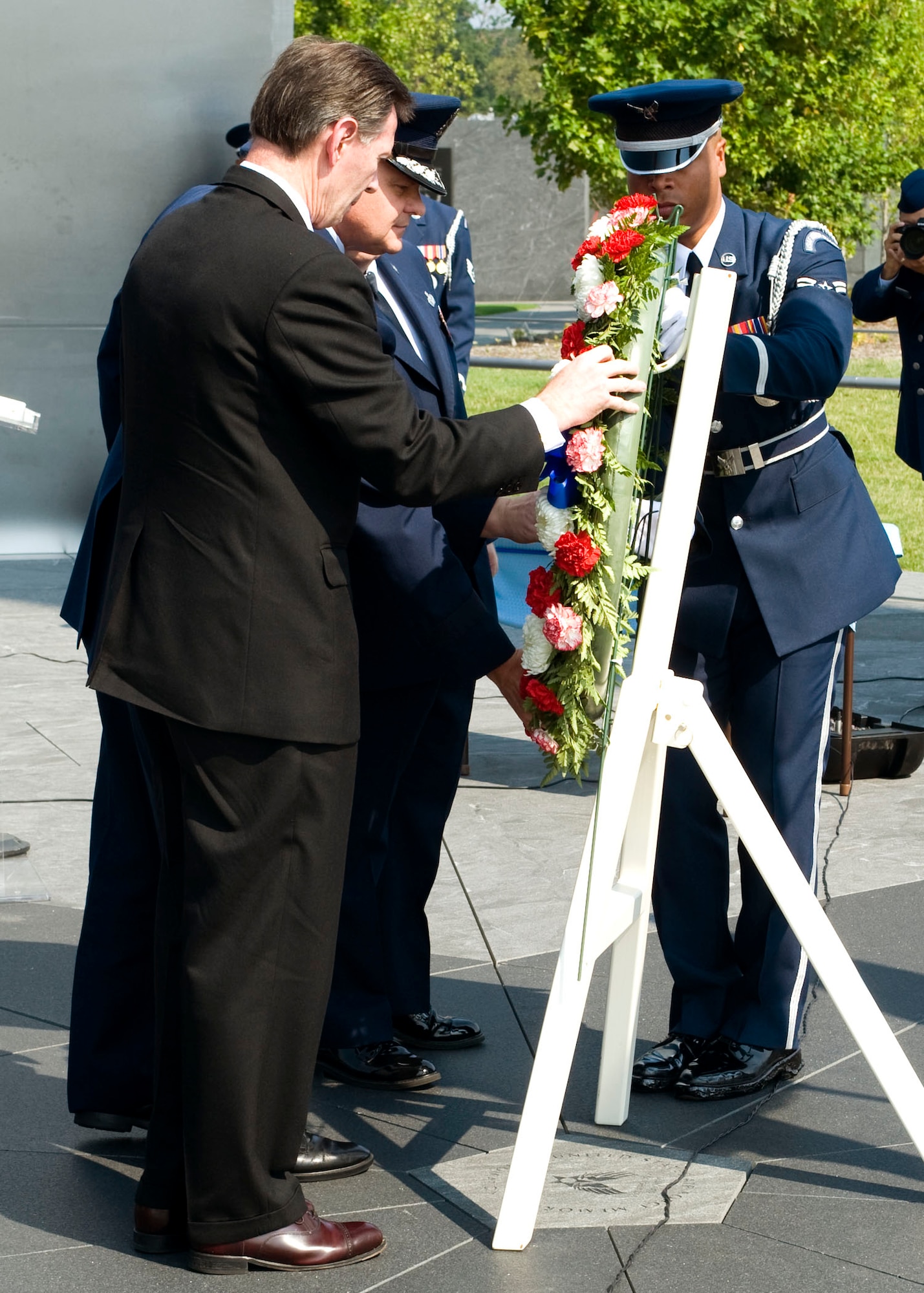 In observance of the 60th Anniversary of the Air Force Office of Special Investigations a wreath is placed at the Air Force Memorial Aug. 1. Positioning the wreath are (l to r) Mr. Douglas Thomas, AFOSI Executive Director, Command Chief Master Sgt. Chris Redmond , AFOSI Command Chief, Brig. Gen. Dana Simmons, AFOSI commander and an Airman from the Air Force Honor Guard. (U.S. Air Force photo/Mike Hastings)