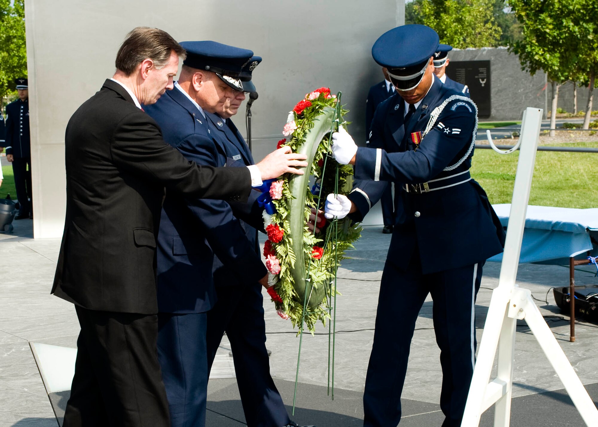 In observance of the 60th Anniversary of the Air Force Office of Special Investigations a wreath is placed at the Air Force Memorial Aug. 1. Positioning the wreath are (l to r) Mr. Douglas Thomas, AFOSI Executive Director, Brig. Gen. Dana Simmons, AFOSI commander, Command Chief Master Sgt. Chris Redmond, AFOSI Command Chief, and an Airman from the Air Force Honor Guard. (U.S. Air Force photo/Mike Hastings)