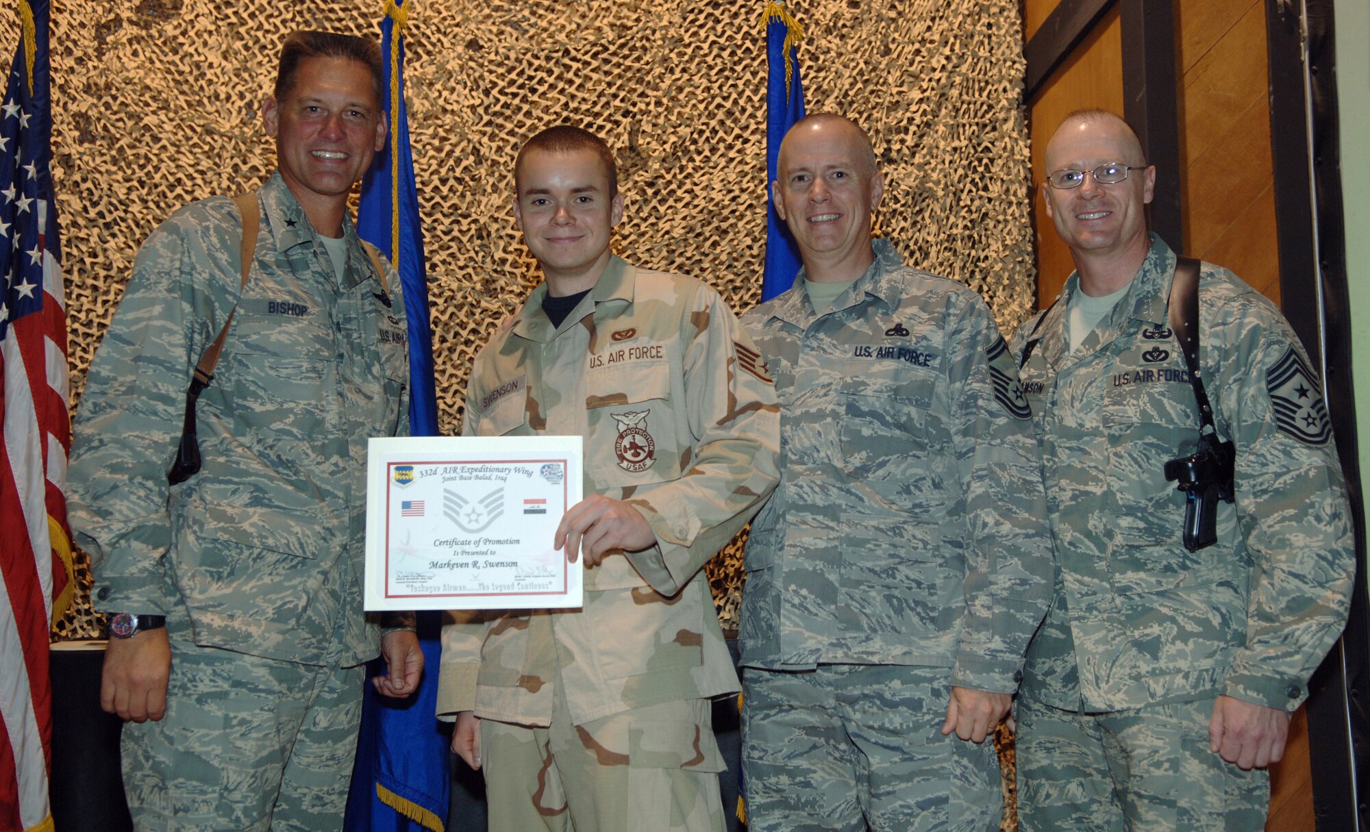 JOINT BASE BALAD, Iraq -- Staff Sgt. Markeven Swenson accepts his promotion from Brig. Gen. Brian Bishop at a 332nd Air Expeditionary Wing promotion ceremony here July 31. Sergeant Swenson’s father, Senior Master Sgt. Kevin Swenson, flew in from Forward Operating Base Marez during his four-day rest-and-relaxation period to tack on his son’s stripes. Sergeant Markeven Swenson, a firefighter with the 332nd Expeditionary Civil Engineer Squadron here, is deployed from Moody Air Force Base, Ga. His father, a ground radio communications maintenance technician, is deployed from Yokota Air Base, Japan. General Bishop is the 332nd AEW commander. Also pictured is 332nd AEW Command Chief Master Sgt. David Williamson. (U.S. Air Force photo/Tech. Sgt. Richard Lisum)