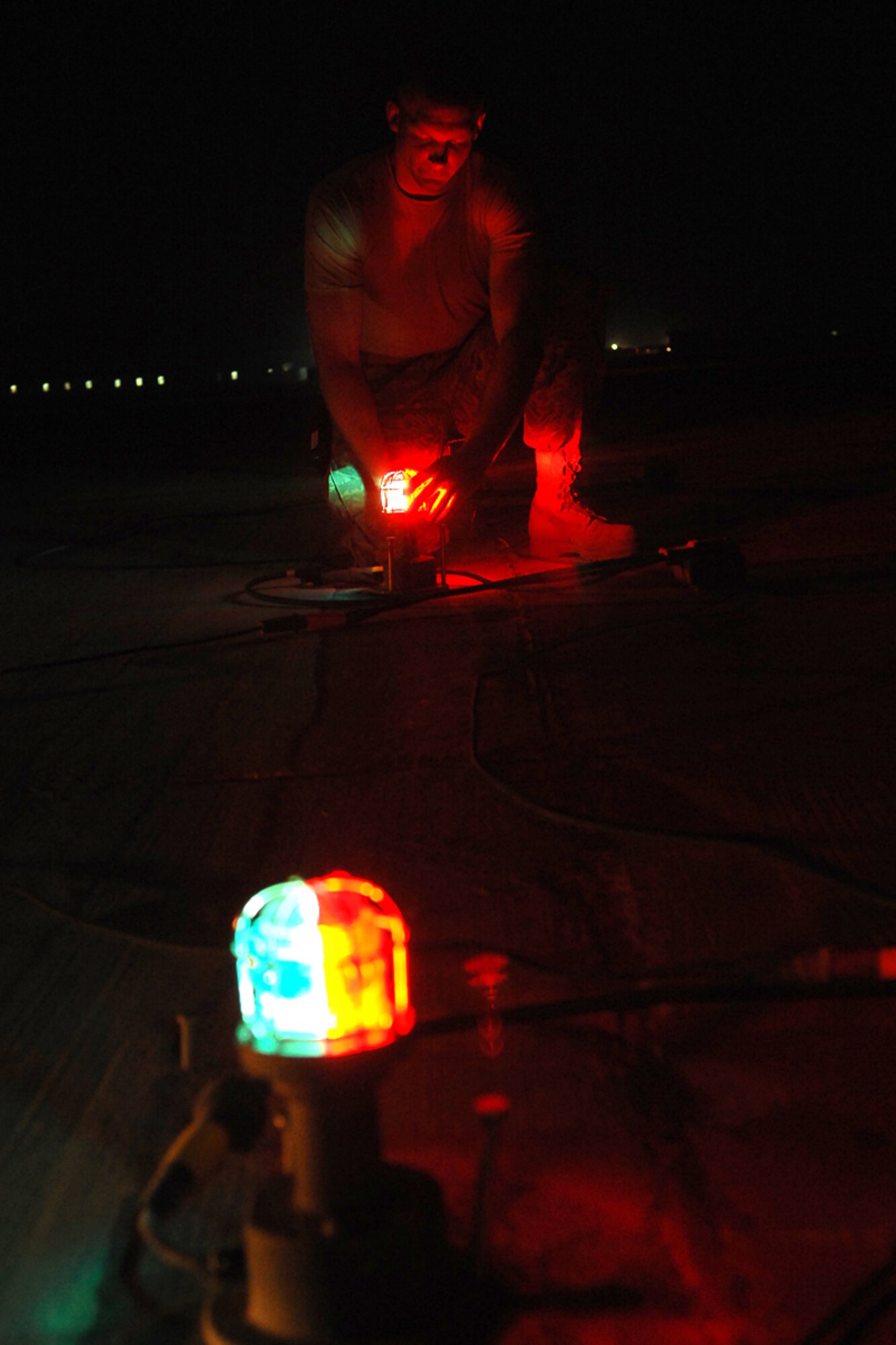 KIRKUK REGIONAL AIR BASE, Iraq -- Senior Airman Mitchell Robinson, 506th Civil Engineer Squadron electrician, tests the runway lights here August 1.  Airman Robinson is one of 10 electricians deployed here who average 55 job orders each week around the installation.  Airman Robinson is deployed from F.E. Warren Air Force Base, Wyo., and calls Marshall, Mich., home. (U.S. Air Force photo/Senior Airman Randi Flaugh)