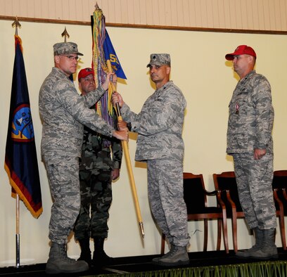 ANDERSEN AIR FORCE BASE - Col. Daniel Settergen, 36th Contingency Response Group commander, presents the 554th RED HORSE Squadron guidon to Lt. Col. Anthony J. Davit signifying the change of command at a ceremony held Aug. 2 at the Oceanview Conference Center.  Lieutenant Colonel Davit comes to Andersen following his assignment as the deputy commander of the 823rd RHS at Hurlburt Field, Fla. (U.S. Air Force photo by Airman 1st Class Courtney Witt)
