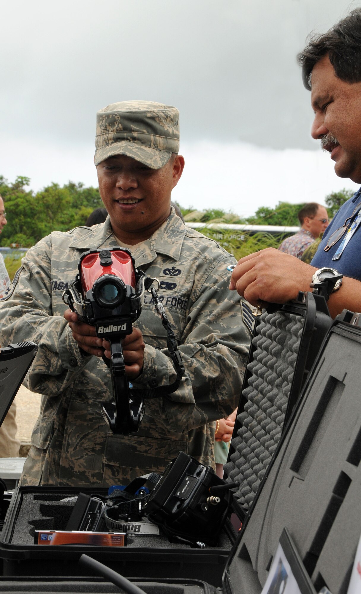 ANDERSEN AIR FORCE BASE, Guam - Staff Sgt. Francis Tagalog of the 36th Civil Engineer Squadron Fire Department explains how to use a thermal imaging camera at a DoD no-notice mass causality airport disaster workshop at Won Pat International Airport July 31. One purpose of workshop was to show emergency response elements what equipment and capabilities are available around Guam as an effort to improve their response during future emergency situations. (U.S. Air Force photo by Airman 1st Class Courtney Witt)
