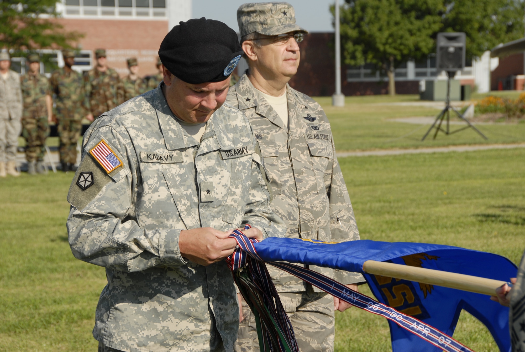 Brig. Gen. Timothy K. Kadavy, Adjutant General Nebraska,(center) pins the ninth Air Force Outstanding Unit Award streamer on the 155th Air Refueling Wing flag during a Honors Ceremony held at the Nebraska Air National Guard base on 3 August, 2008. The 155th ARW was cited for support of Homeland Defense, Operation Noble Eagle, Operation Iraqi Freedom, Environmental Protection, Compliance Inspections, Community Involvement, and Flying Safety.  (Nebraska Air National Guard photo by Master Sgt. Alan Brown)(Released)
