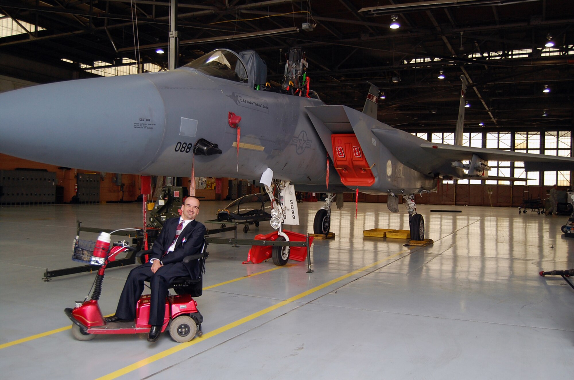 Willie "Wild Man" Deuster takes a time out from his tour of the F-15 to pose with the aircraft.  Deuster was the guest for the Brown Bag Speaker Series May 3.