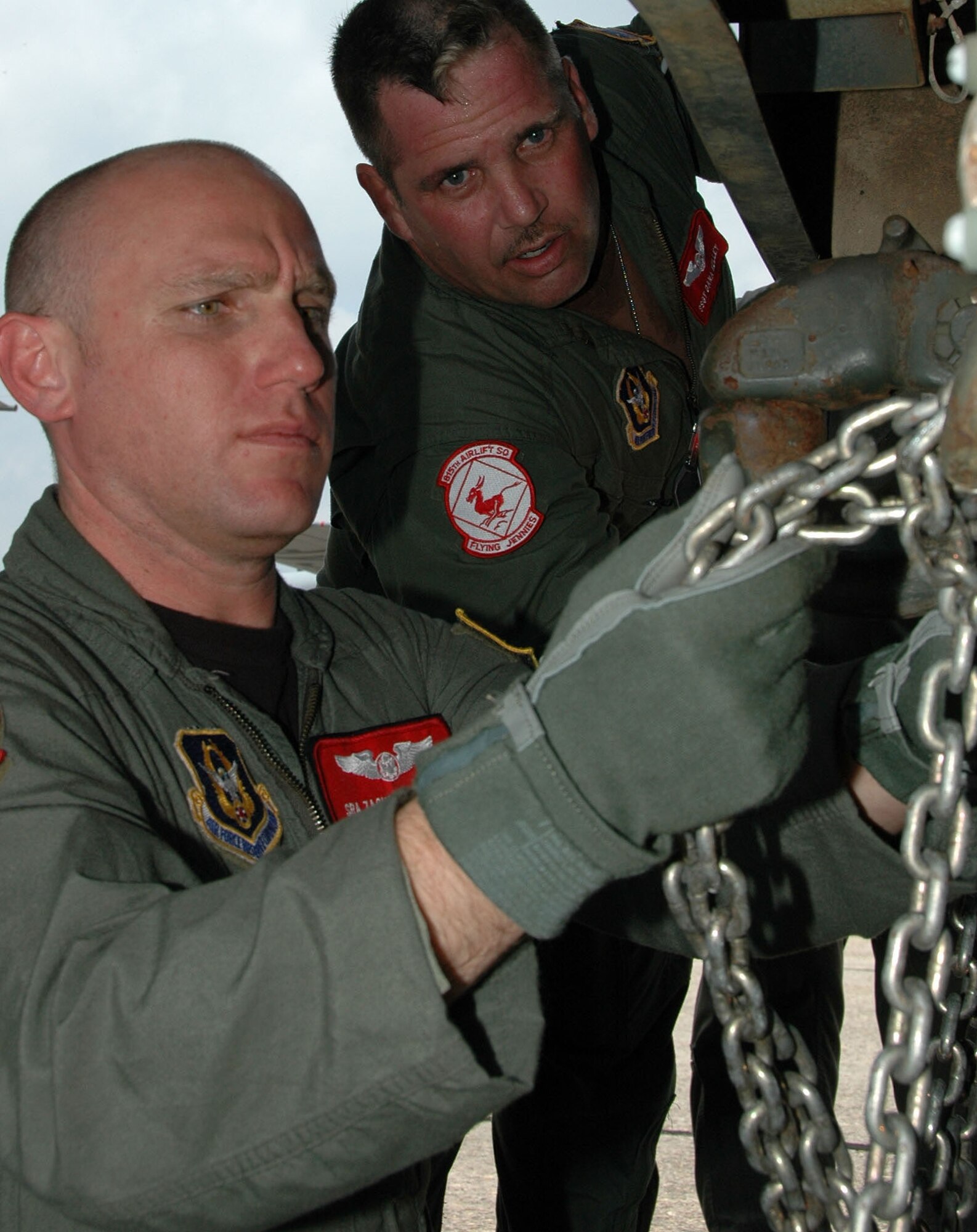 KEESLER AIR FORCE BASE, Miss.--Senior Airman Zachary Zieman (left) and Staff Sgt. Dana Kelley, 815th Airlift Squadron loadmasters, hook up a chain to the back of a M35 2.5 ton cargo truck, also known as a "deuce-and-a-half." During the 403rd Wing's August Unit Training Assembly, Citizen Airmen of the 815th AS and the 41st Aerial Port Squadron practiced loading and offloading the truck onto one of the squadron's C-130J-30 aircraft. The C-130J-30 is a "stretched" version of the J-model with 15 additional feet in length allowing crews to load more cargo than legacy C-130s. Rather than backing the vehicle onto the plane, they used the truck to simulate heavy, stationary cargo that needed to be on-loaded using a system of chains, hooks and pulleys. (U.S. Air Force Photo/Tech. Sgt. Ryan Labadens)