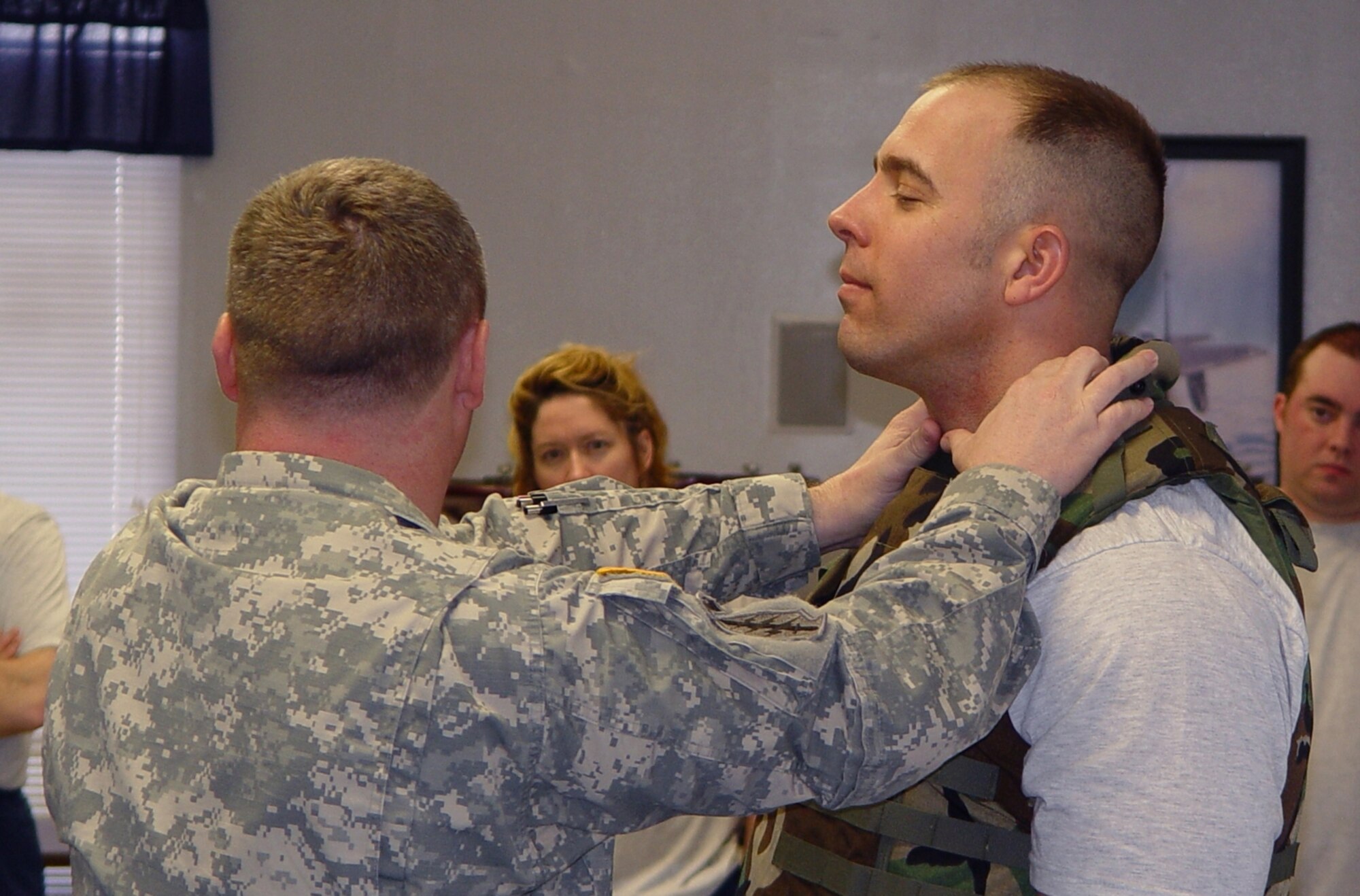 Army 1st Lt. Andrew Myatt demonstrates a choking technique on Maj. Darren Guttmann.  Flak jackets are worn during training to allow for stronger body strikes.                               