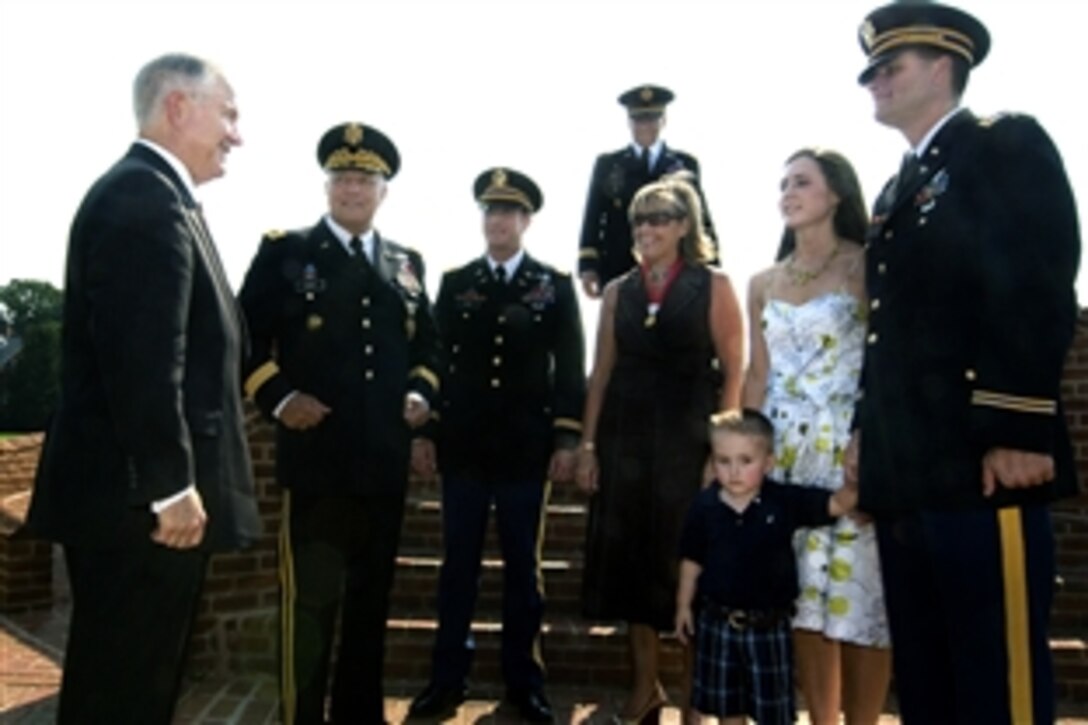 Defense Secretary Robert M. Gates, left, greets retired Army Gen. Richard Cody, second from left, and his family following Cody's retirement ceremony on Fort Myer, Va., Aug. 1, 2008. Cody, the Army's 31st vice chief of staff, retired after 36 years years of service.