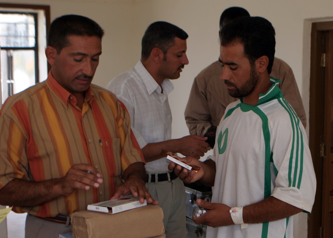 JAZEERA, Iraq (August 3, 2008) – An Iraqi doctor gives prescribes medicine during a Combined Medical Engagement at the al Rashid school, Aug. 3. Iraqi doctors and their assistants, with the support of Navy doctors and hospital corpsmen, provided much needed service to the Jazeera community. (Official U.S. Marine Corps photo by: Lance Cpl. Scott Schmidt) (RELEASED)