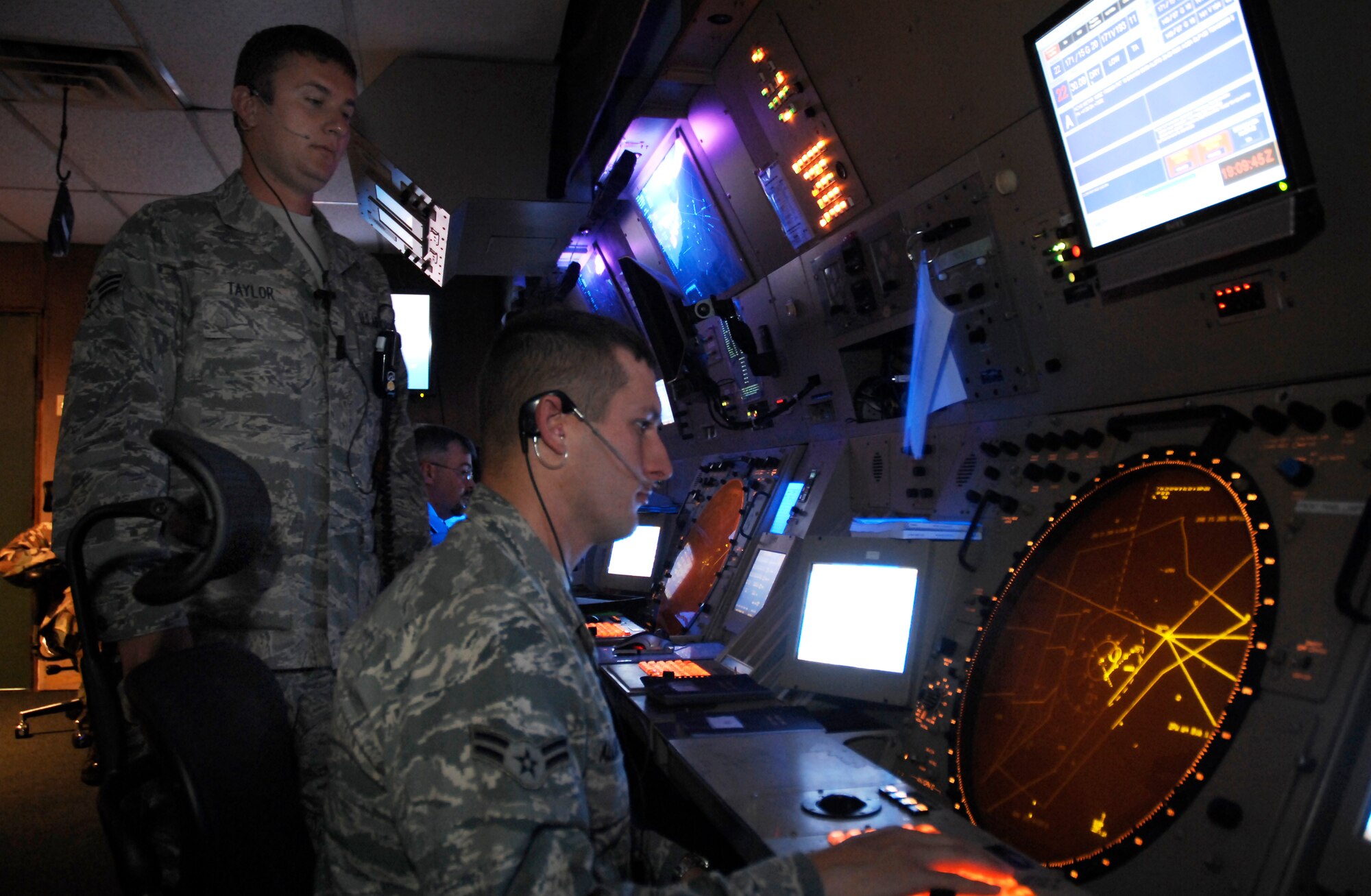 CANNON AIR FORCE BASE, N.M. -- Airman 1st Class Dustin Allred and Senior Airman Braden Taylor, 27th Special Operations Support Squadron, provide airflow for aircraft flying over Cannon Air Force Base Aug. 4. Air traffic controllers perform duties within a radar facility and maintain radar surveillance of approach control airspace, processing and coordinating aircraft through terminal control.  (U.S. Air Force photo/Senior Airman Liliana Moreno)