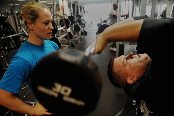 MOODY AIR FORCE BASE, Ga. -- Erin Carter, Chi Alpha Fitness physical trainer, encourages Tech. Sgt. Carl Anderson, 23rd Maintenance Operations Squadron quality assurance inspector, during a physical training session here July 31. Sergeant Anderson has been training twice a week for four months and has lost a total of eight inches from his waist. (U.S. Air Force photo by Senior Airman Gina Chiaverotti)