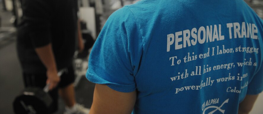MOODY AIR FORCE BASE, Ga. -- Erin Carter, Chi Alpha Fitness physical trainer, instructs Tech. Sgt. Carl Anderson, 23rd Maintenance Operations Squadron quality assurance inspector, while lifting weights here July 31. There are currently six physical trainers available on base at the Freedom I fitness center. (U.S. Air Force photo by Senior Airman Gina Chiaverotti)