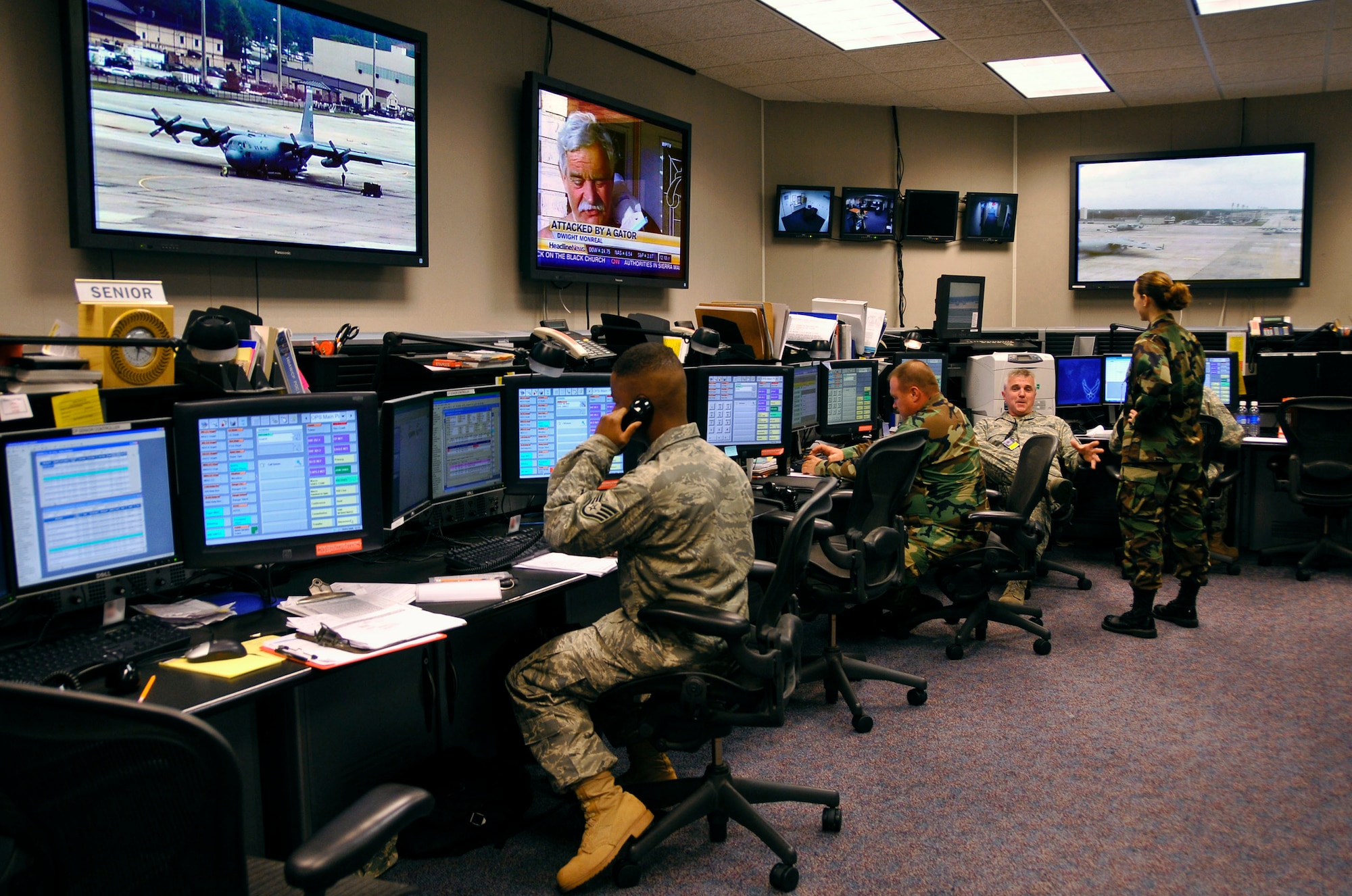 Airmen monitor base activities at the fully-integrated command post monitors in August at Pope Air Force Base, N.C. Reservists and active-duty Airmen work side-by-side to execute the command post mission. (U.S. Air Force photo/Joe Oliva)