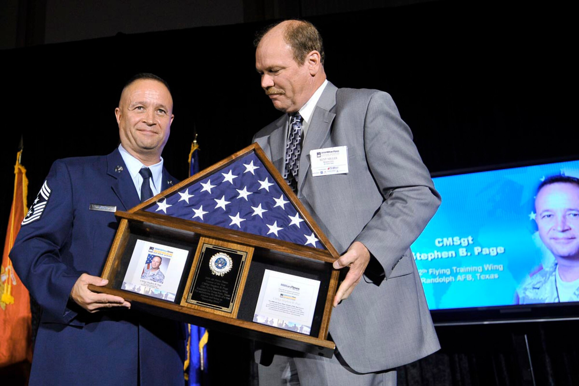 Chief Master Sgt. Stephen Page accepts the Air Force Times newspaper's Airman of the Year award.  Presenting the award is Kent Miller from the Military Times newspaper group at an awards reception July 30 in Washington, D.C. (U.S. Air Force photo by Scott M. Ash)