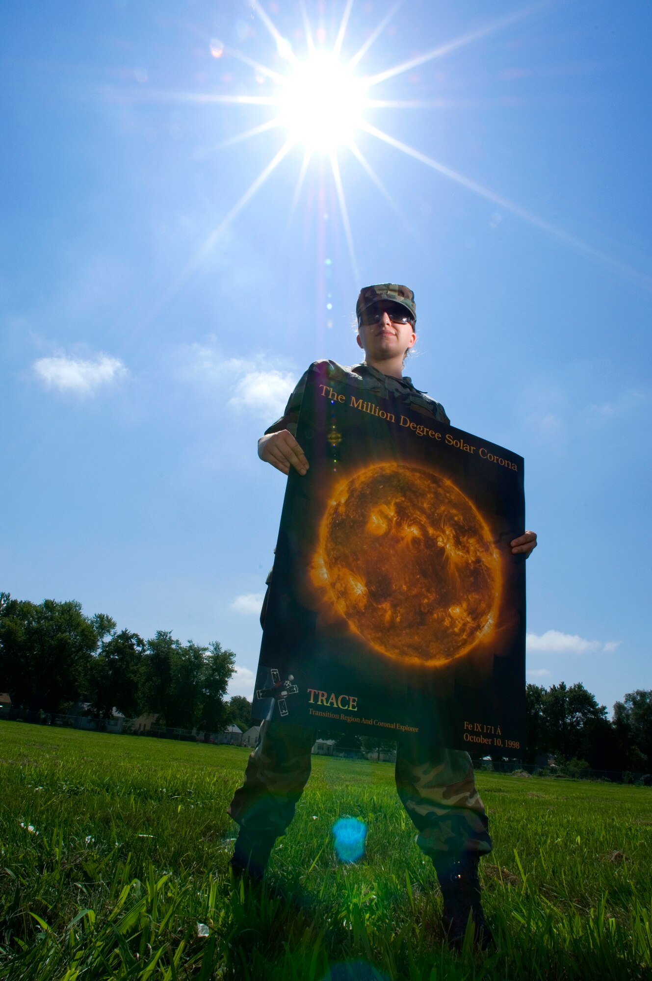 Staff Sgt. Kelly Miller holds a poster depicting solar flares on the sun at a million degree exposure. As a space weather forecaster, Sergeant Miller interprets and analyzes atmospheric and solar activity to find potential effects and impacts on the mission caused by geomagnetic storms and high-velocity solar winds.  Sergeant Miller is with the 2nd Weather Squadron at Offutt Air Force Base, Neb. (U.S. Air Force photo/Staff Sgt. Bennie J. Davis III)