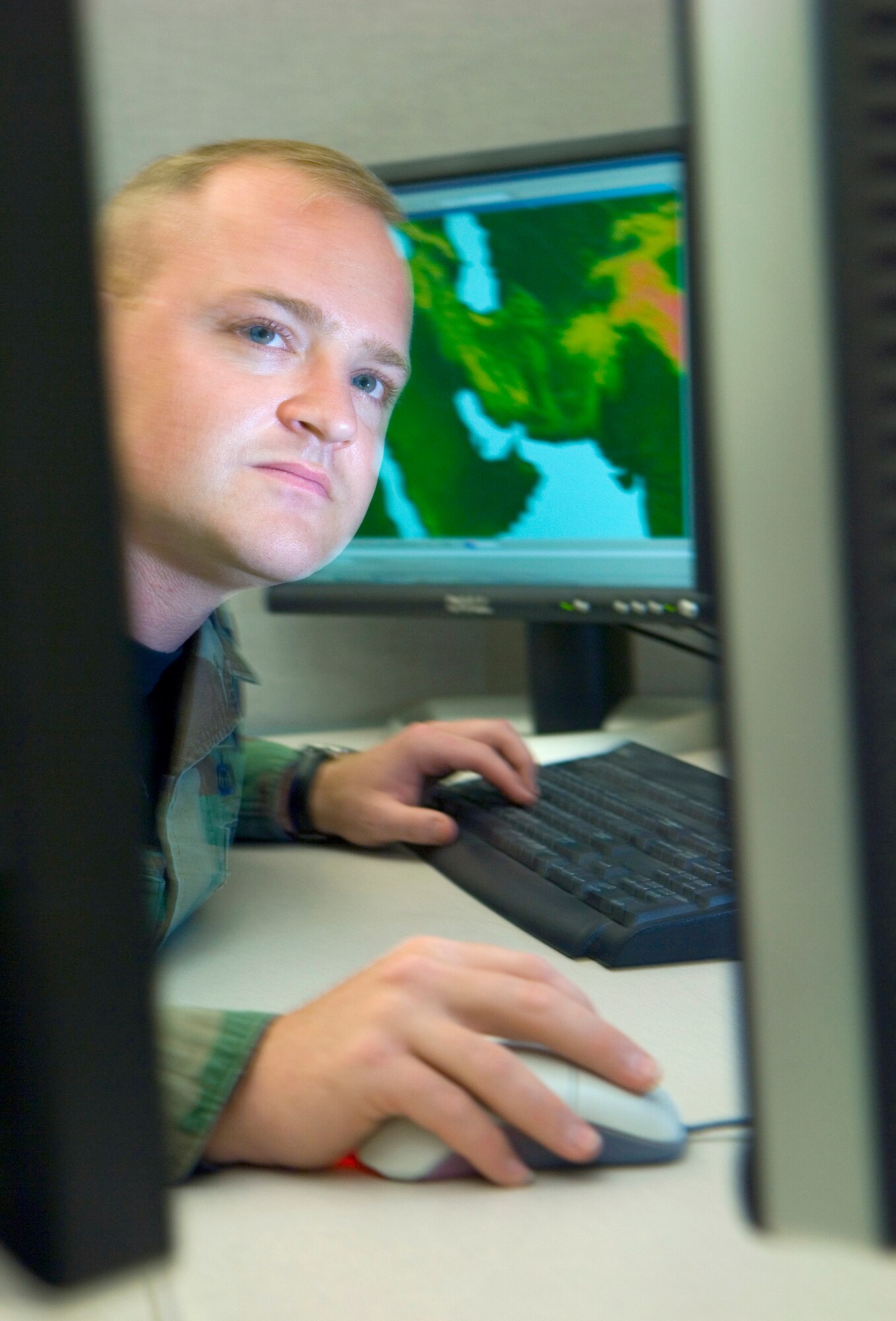 Tech. Sgt. Jason Miller, NCO in charge of the cloud obscurant forecast and analysis cell at the Air Force Weather Agency, analyzes cloud bases for Southwest Asia using a new program developed to provide regional-specific data.  Sergeant Miller is with the 2nd Weather Squadron at Offutt Air Force Base, Neb. (U.S. Air Force photo/Staff Sgt. Bennie J. Davis III)