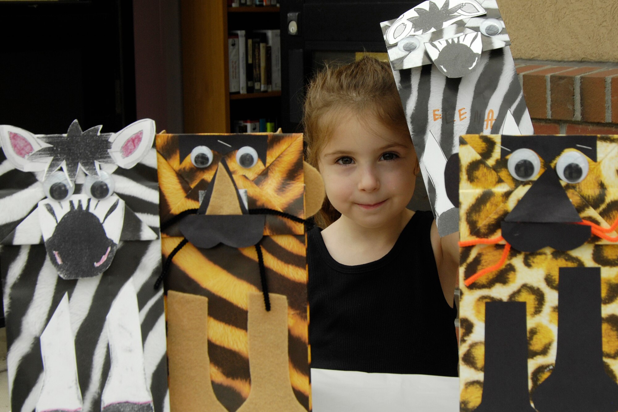 HANSCOM AFB, Mass. – Elena Weissman proudly displays the puppet she created on July 31 at the Base Library. The Library hosted a crafting event and celebration to mark the conclusion of the Wild Reads Summer Reading Program. (U.S. Air Force photo by Linda LaBonte Britt)